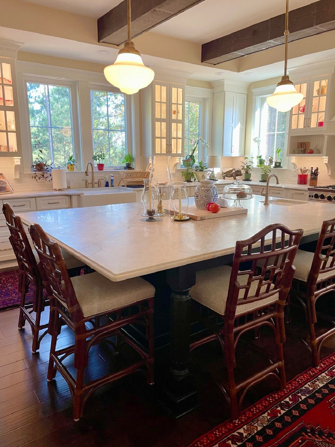 Hello Lovely - traditional kitchen with black island, white custom cabinets, Taj Mahal quartzite, farm sink, Bluestar range, and Chippendale stools. #traditionalkitchens #twotonekitchen