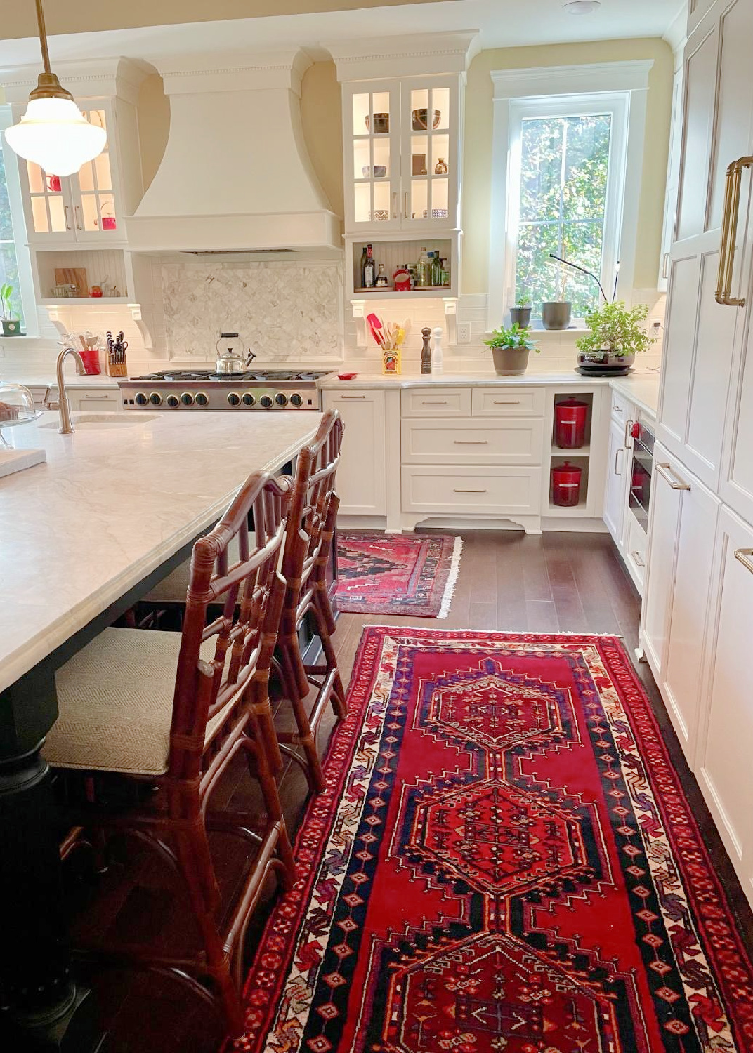 Hello Lovely - traditional kitchen with black island, white custom cabinets, Taj Mahal quartzite, farm sink, Bluestar range, and Chippendale stools. #traditionalkitchens #twotonekitchen