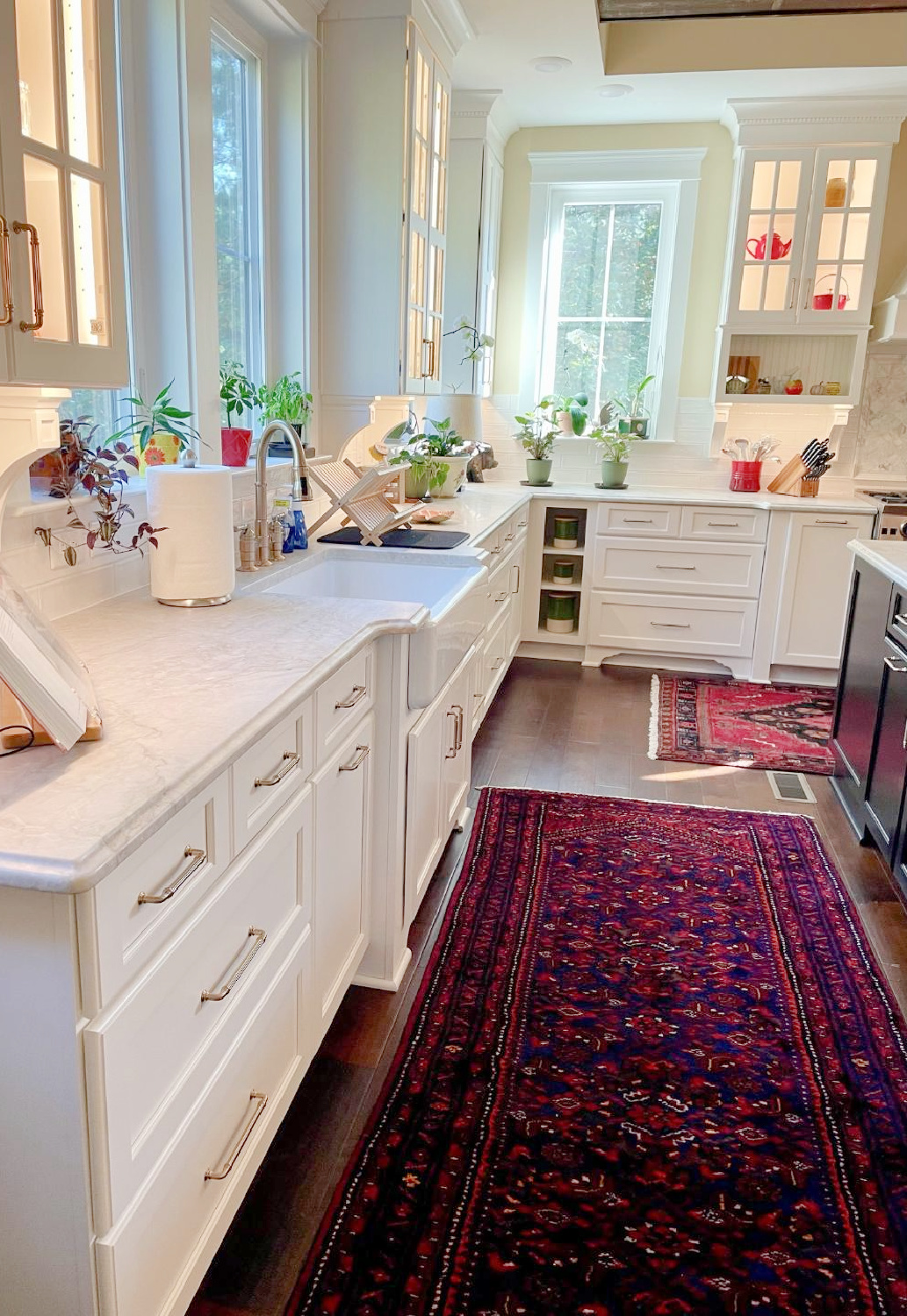 Hello Lovely - traditional kitchen with black island, white custom cabinets, Taj Mahal quartzite, farm sink, Bluestar range, and Chippendale stools. #traditionalkitchens #twotonekitchen