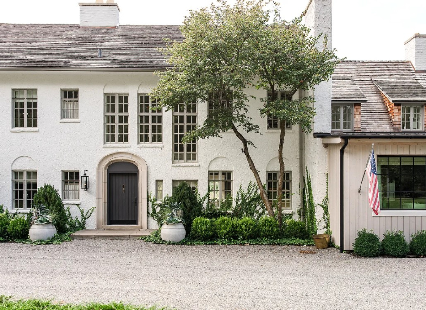 Front facade of Kate Marker's 1920 white stucco Barrington Hills Home (160 N. Buckley Rd) with modern, serene, unfussy, timeless interiors. #katemarkerinteriors @thedawnmckennagroup #katemarkerhome