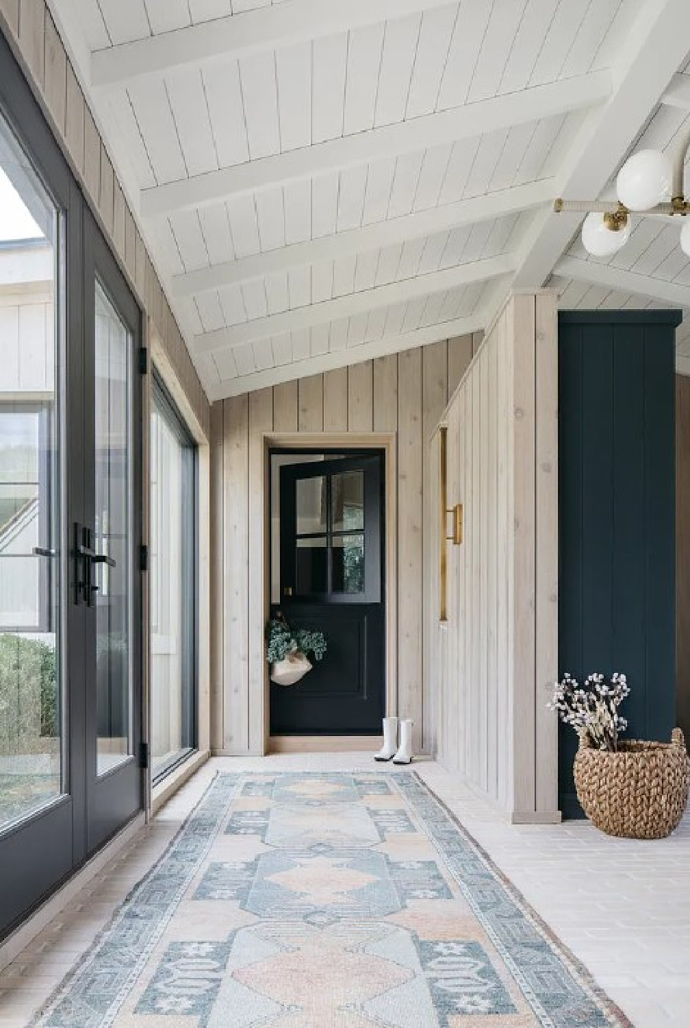 Breezeway and Dutch door in Kate Marker's 1920 white stucco Barrington Hills, IL Home (160 N. Buckley Rd) with modern, serene, unfussy, timeless interiors. #katemarkerinteriors @thedawnmckennagroup #katemarkerhome