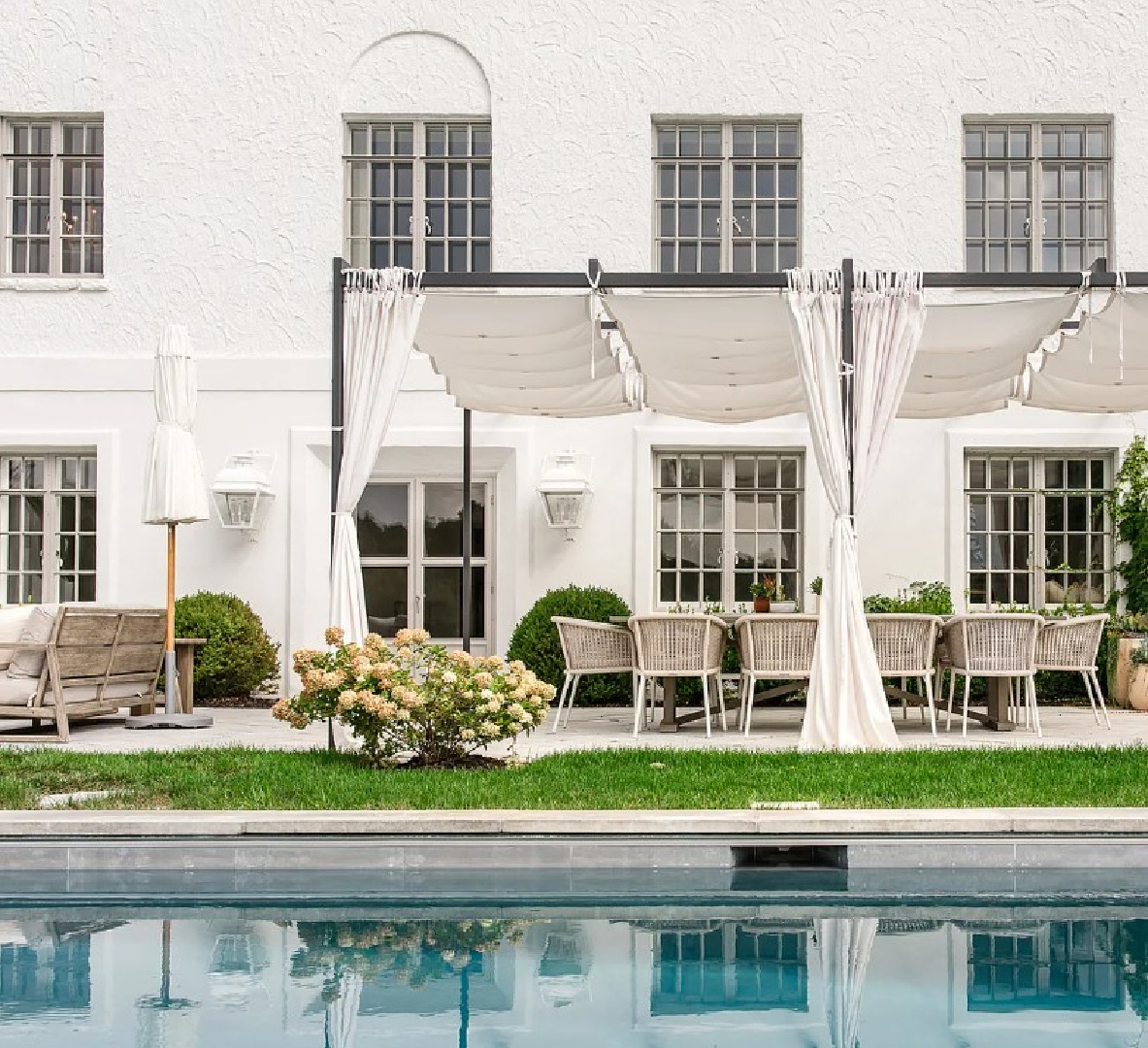 Back exterior of Kate Marker's 1920 white stucco Barrington Hills Home (160 N. Buckley Rd) with modern, serene, unfussy, timeless interiors. #katemarkerinteriors @thedawnmckennagroup #katemarkerhome