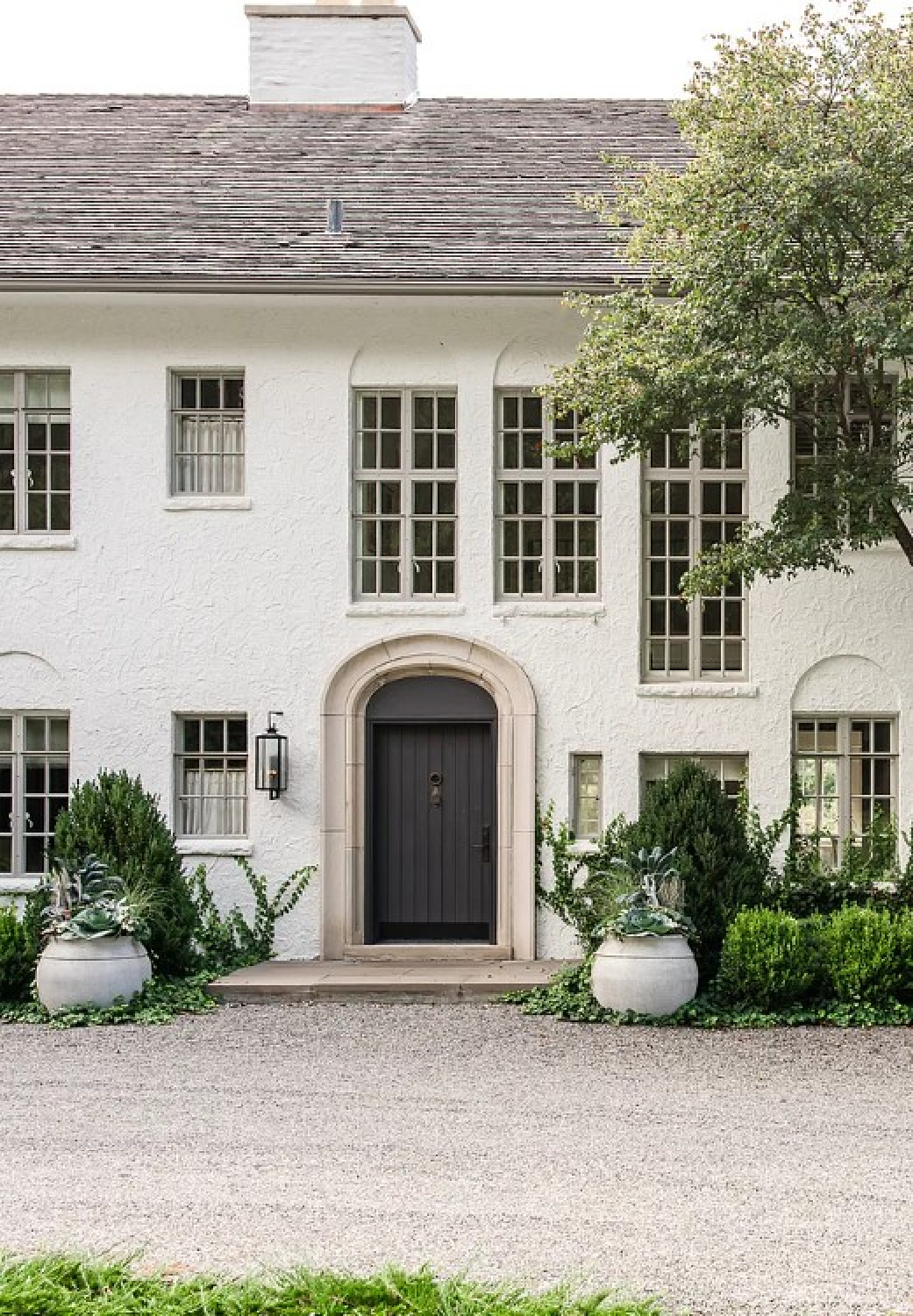 Front facade of Kate Marker's 1920 white stucco Barrington Hills Home (160 N. Buckley Rd) with modern, serene, unfussy, timeless interiors. #katemarkerinteriors @thedawnmckennagroup #katemarkerhome