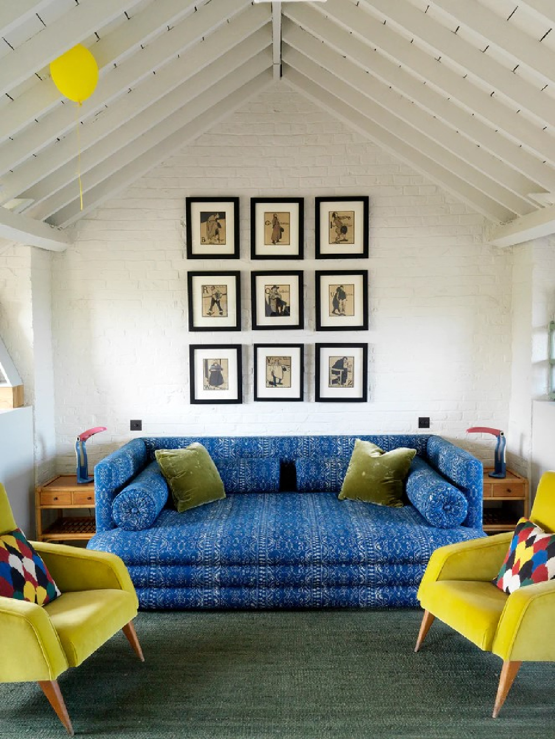 Bold blue sofa and yellow chairs in a space by Beata Heuman - photo by Simon Brown.