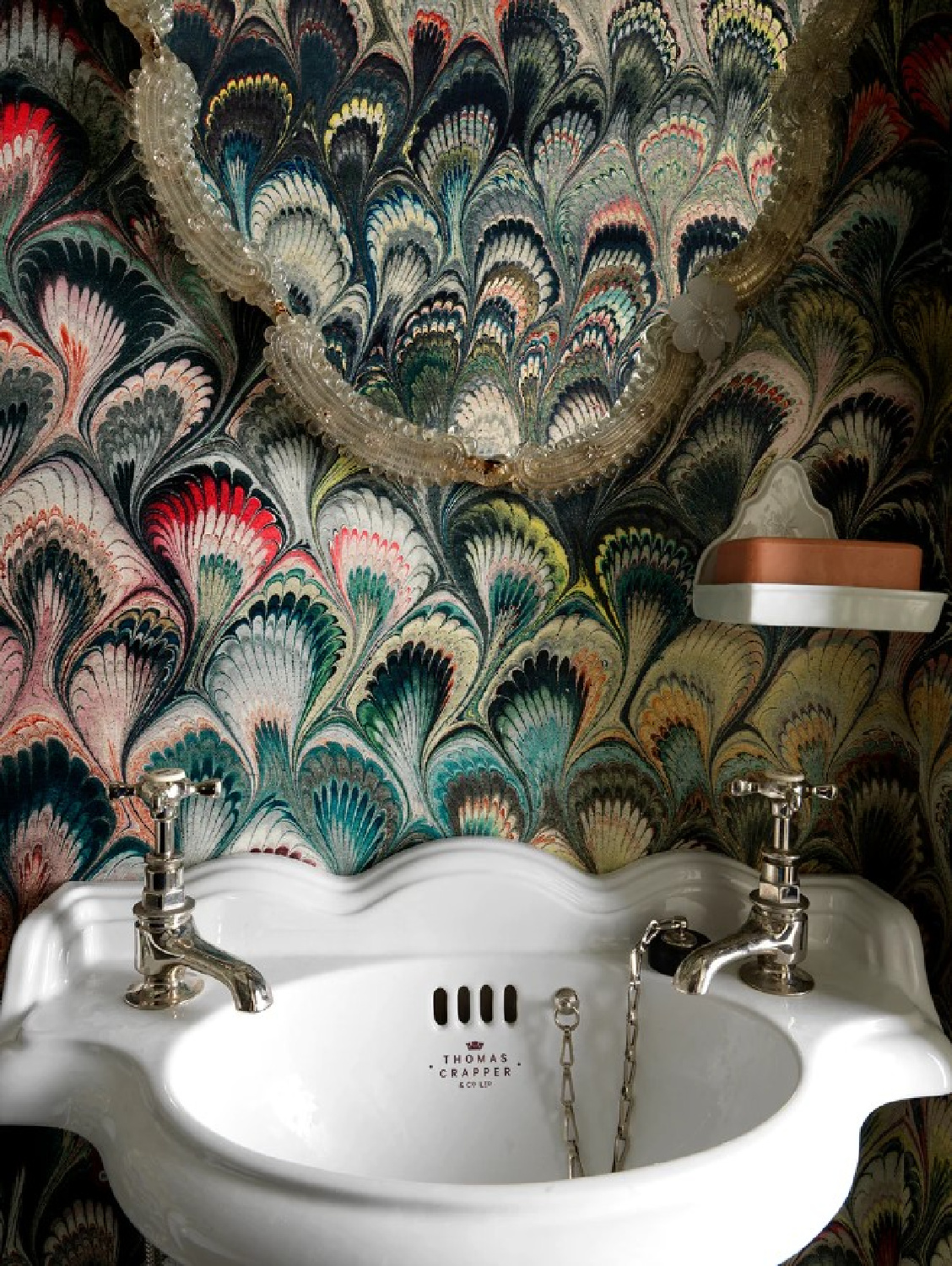 Bold wallcovering and sink with scallops in a Beata Heuman designed bath. Photo: Simon Brown.