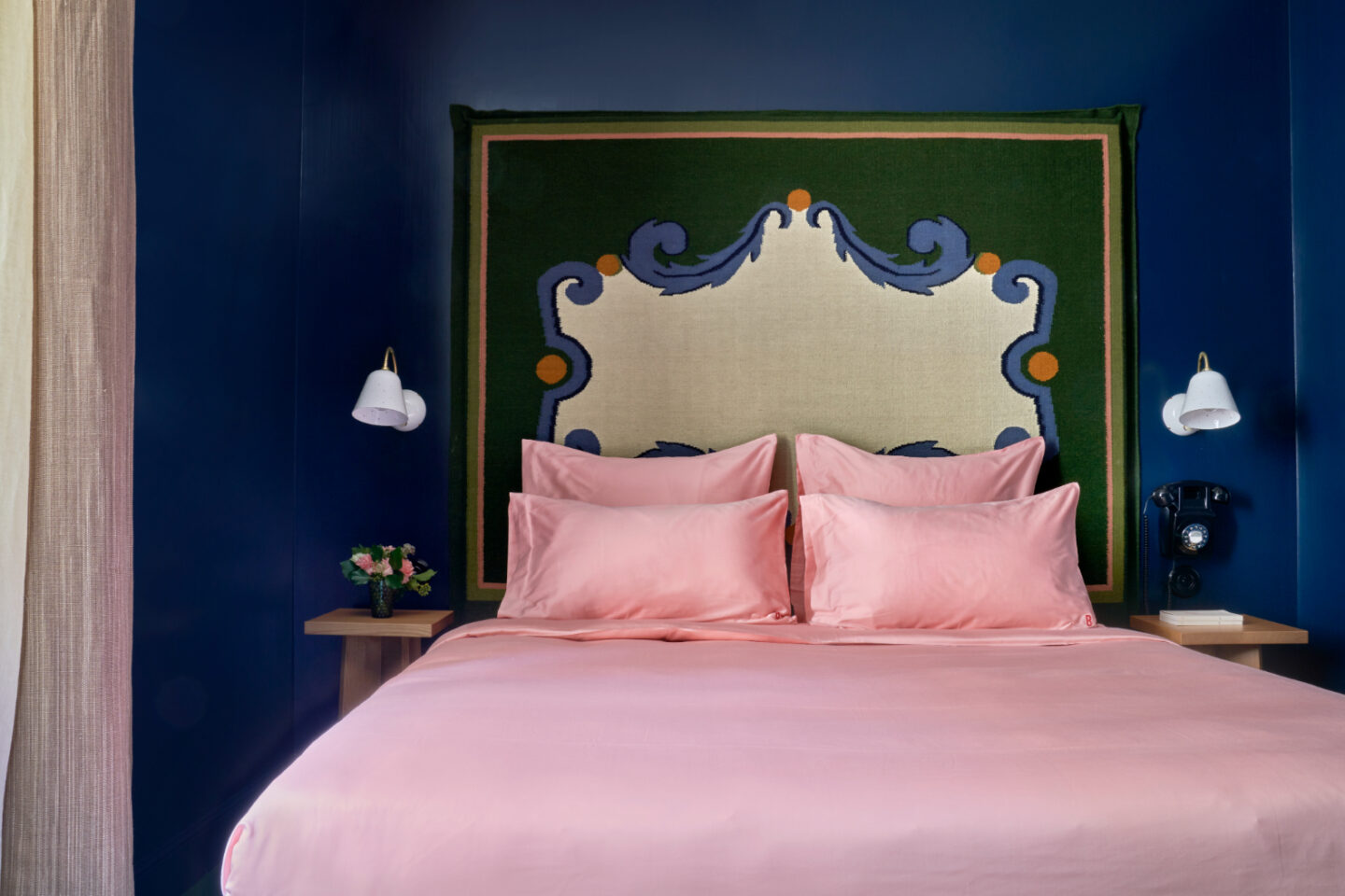 Beata Heuman designed bedroom with deep blue walls in Hôtel de la Boëtie
in Paris.