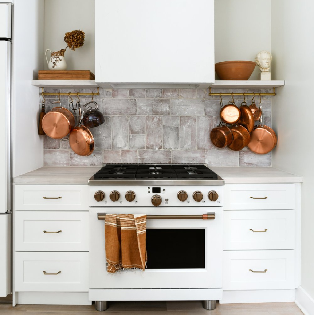 White modern rustic craftsman kitchen with brass pot racks (deVOL) and GE Cafe white range - Leanne Ford. #modernrustic #leanneford