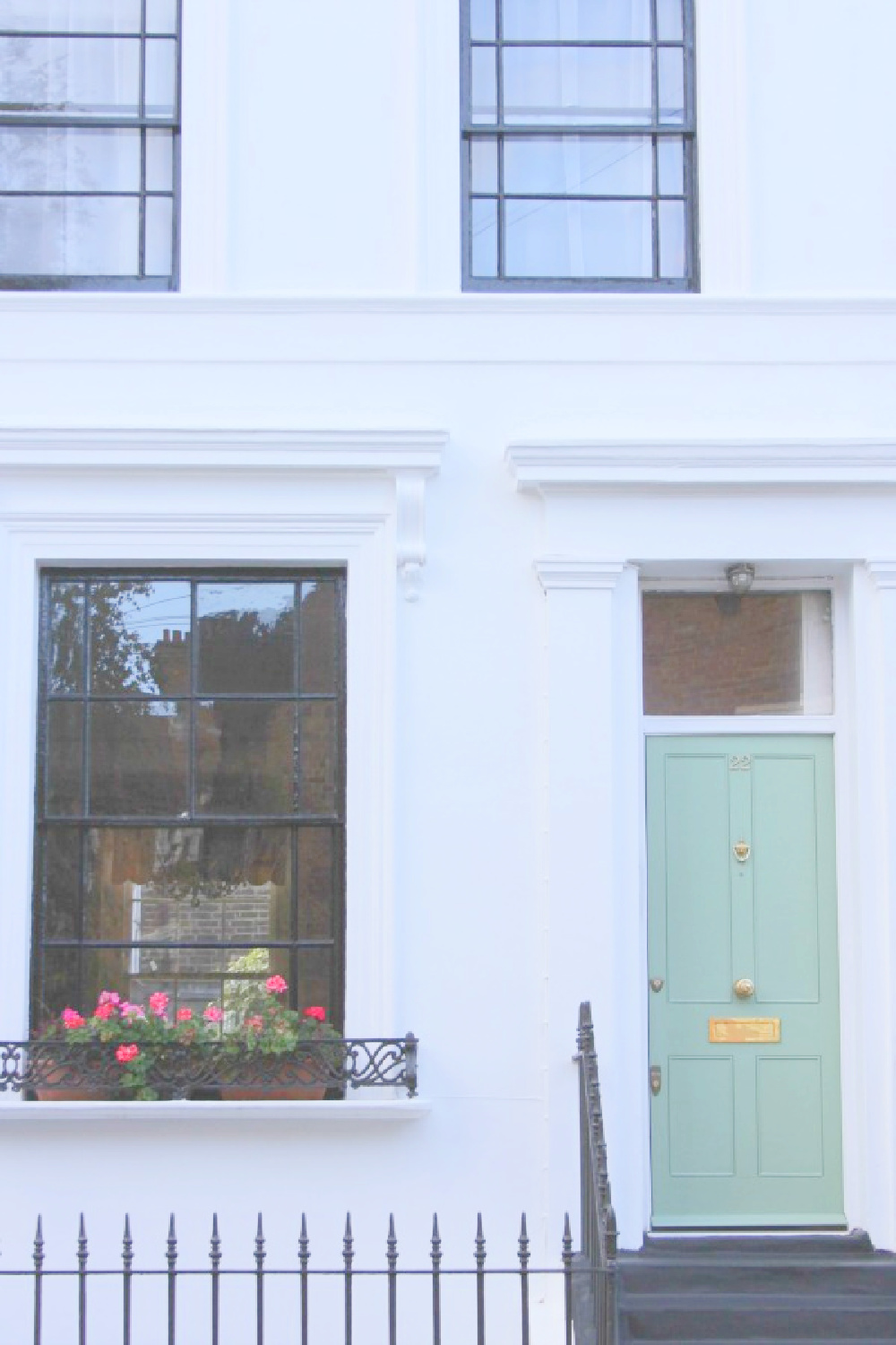 Beautiful light green door in Notting Hill on a white house exterior with black trim - Hello Lovely Studio. #greendoors #lightgreendoor