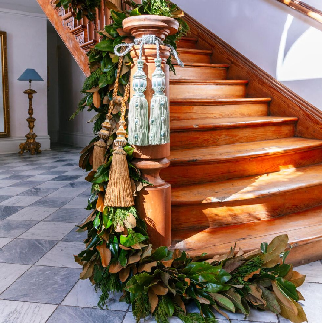 Magnolia and cypress Christmas garland on staircase - Mark Thompson in Veranda (Cedric Angeles). #christmasgarland