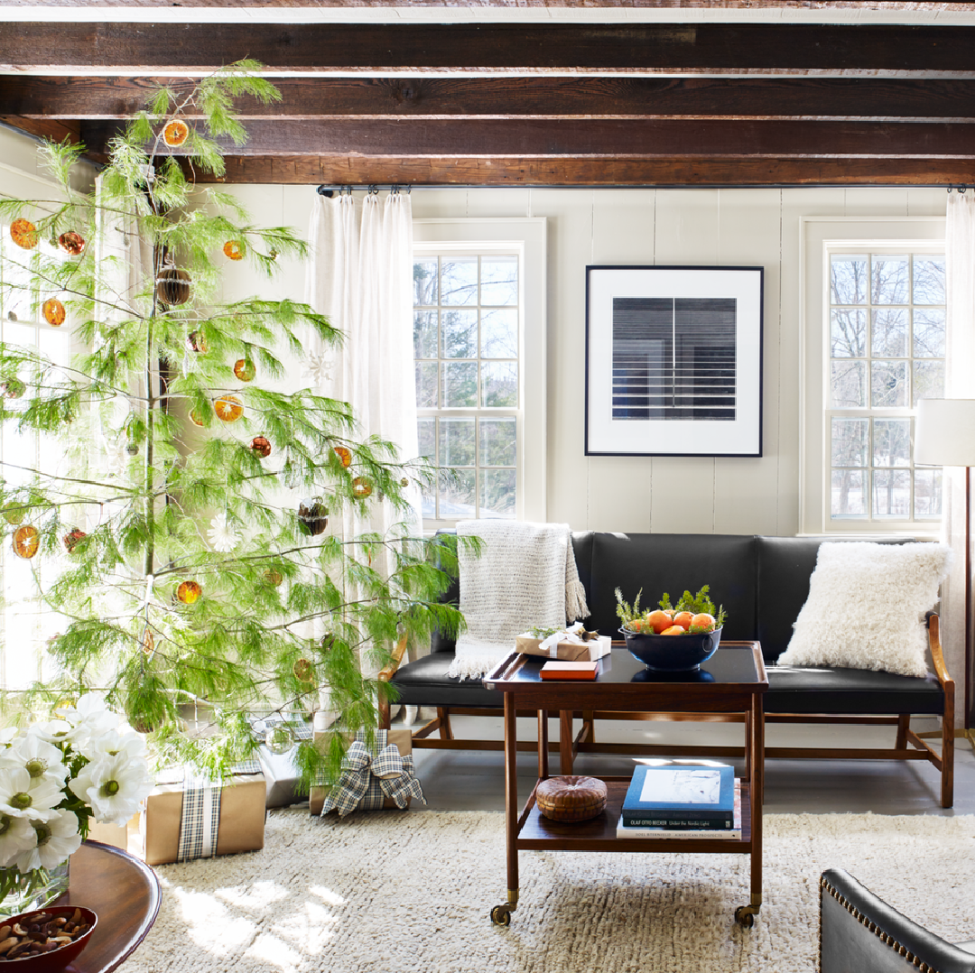 Shawn Henderson designed holiday interior with citrus on tree in a New York farmhouse in Veranda (Francesco Lagnese). #holidaydecor