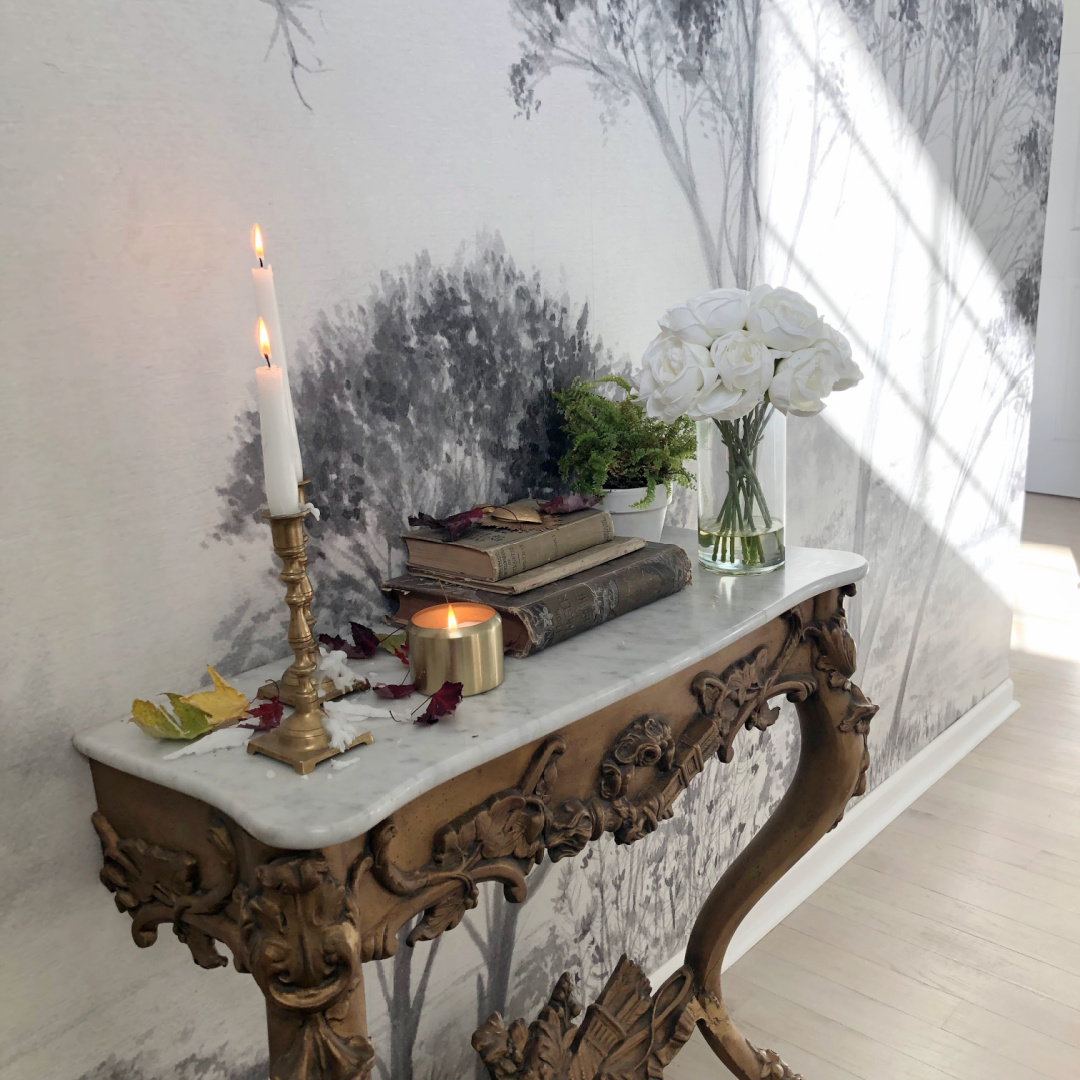 Hello Lovely's entry wallpaper mural with trees (Photowall) and French console with fall decor. #modernfrench #frenchconsole #treemural #grisaillemural