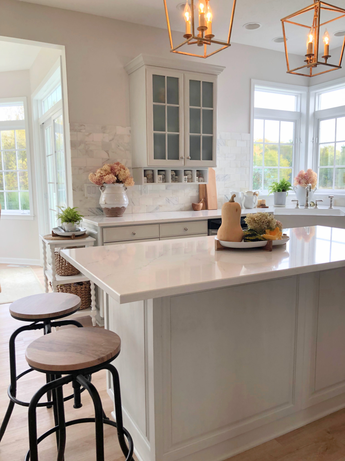 Modern French kitchen with Viatera Muse counters, SW Eider White, and light gray cabinets - Hello Lovely Studio.