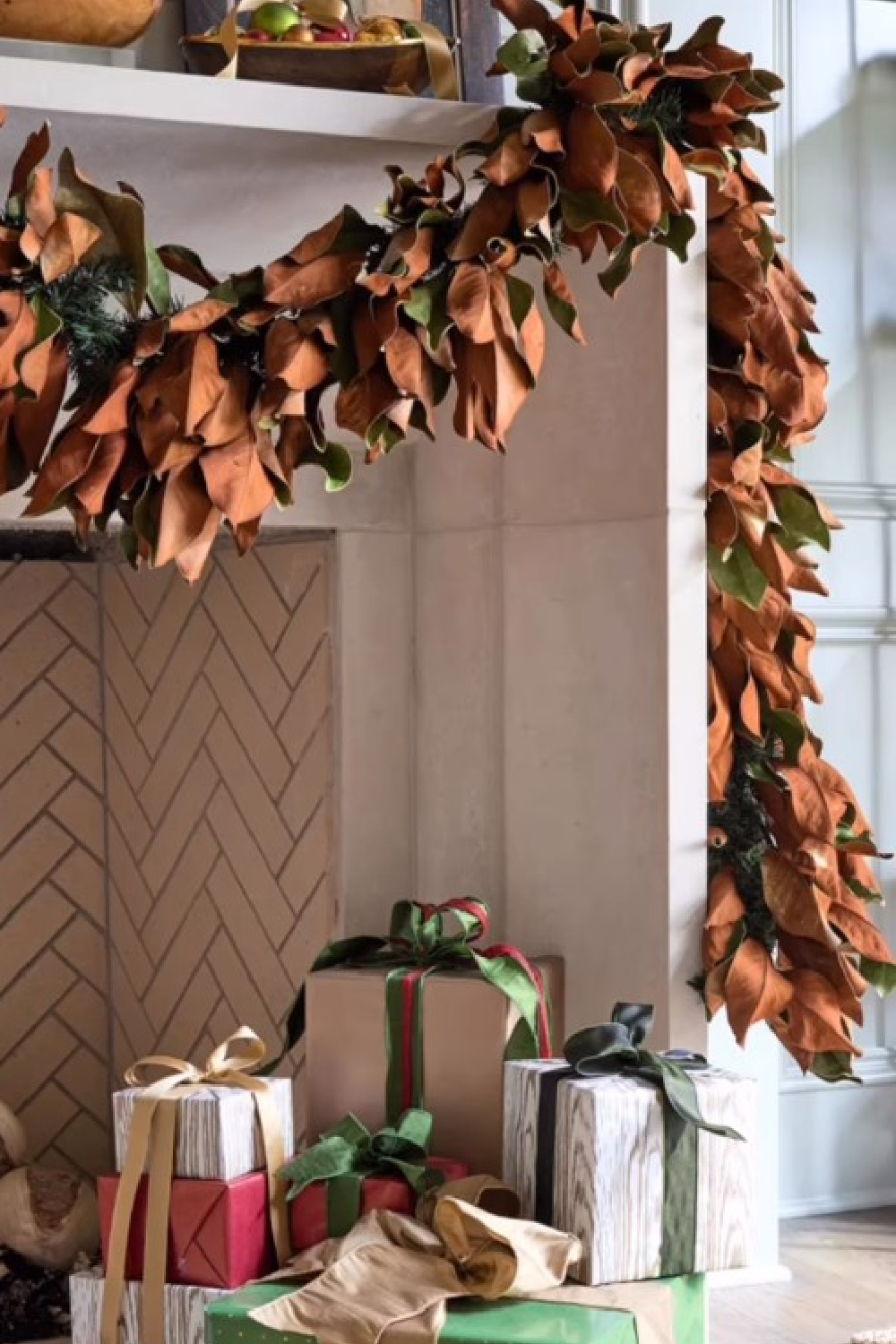 Magnolia garland on limestone fireplace in Atlanta Holiday House - dhcphoto. #holidaydecor #magnoliagarlands