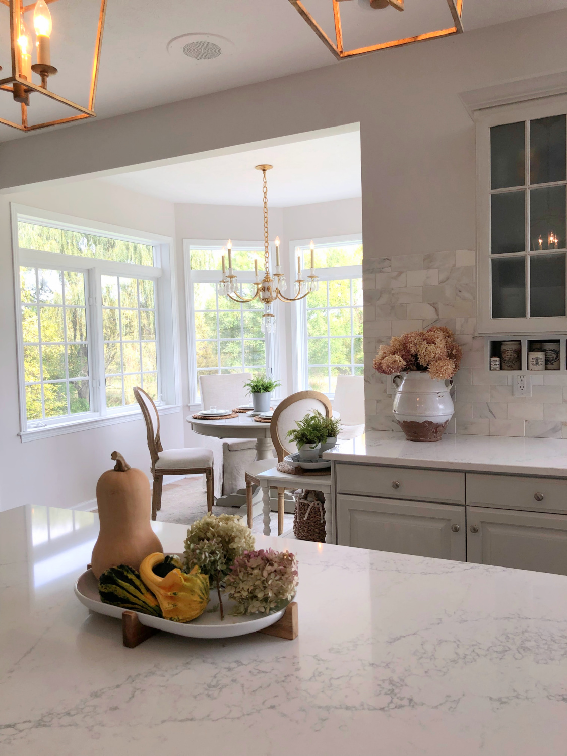 Hello Lovely's fall kitchen with modern French serene style, light gray cabinets, Viatera Muse counter, and gold lighting. #modernfrench #serenekitchen