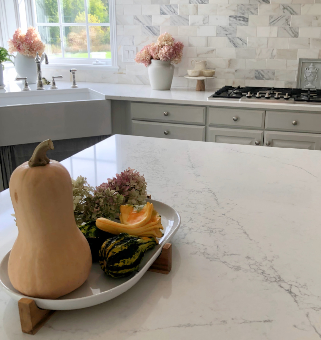 Hello Lovely's fall kitchen with modern French serene style, light gray cabinets, Viatera Muse counter, and gold lighting. #modernfrench #serenekitchen