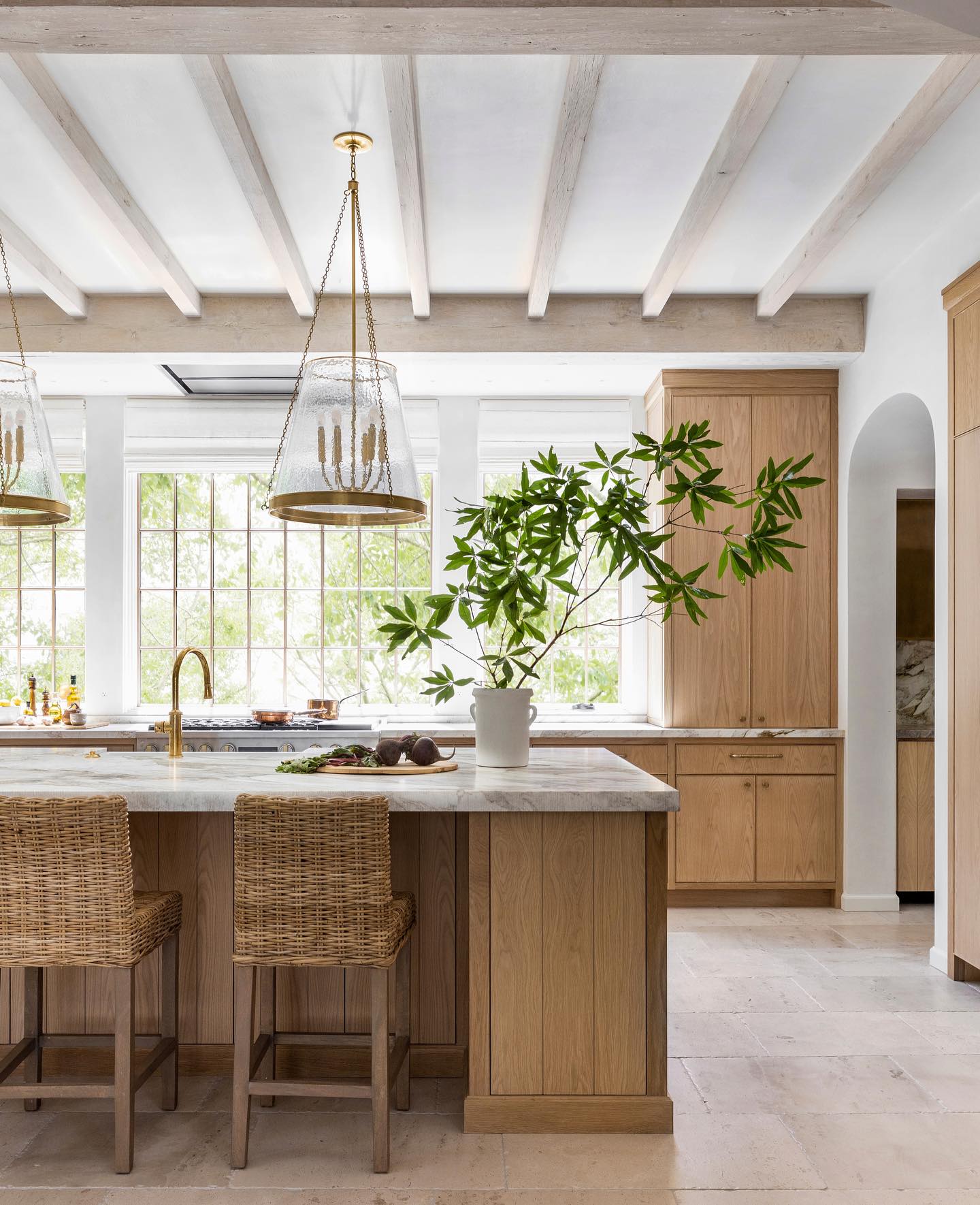 Luxurious bespoke kitchen with wood tone cabinetry - Marie Flanigan Interiors.