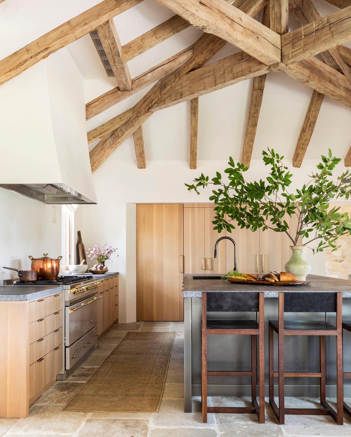 Magnificent architecture and ceiling beams in a bespoke kitchen with design by Marie Flanigan Interiors.