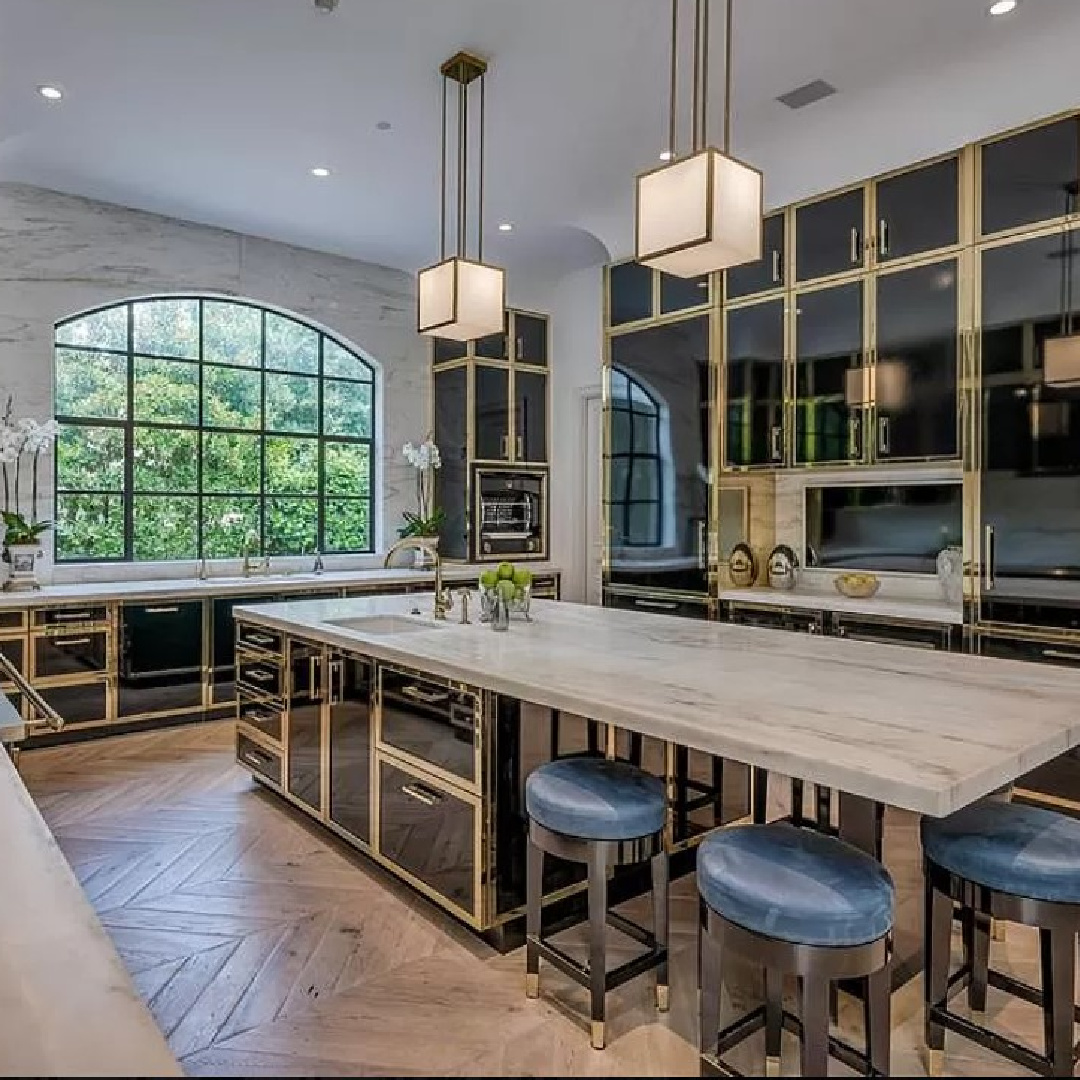 Breathtaking kitchen with Parisian cabinets, brass, chevron floors in Chateauesque French inspired Houston home (Willowick) with fantasy interiors. #fantasyhometour #luxuryhomes