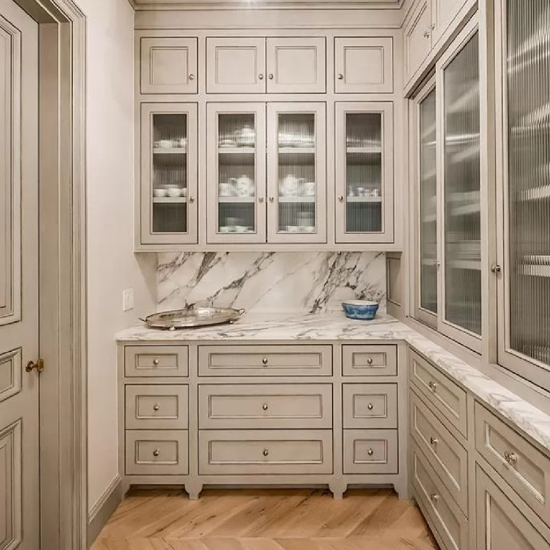 Lovely pale cabinets in a pantry in a luxurious chateau in Houston.