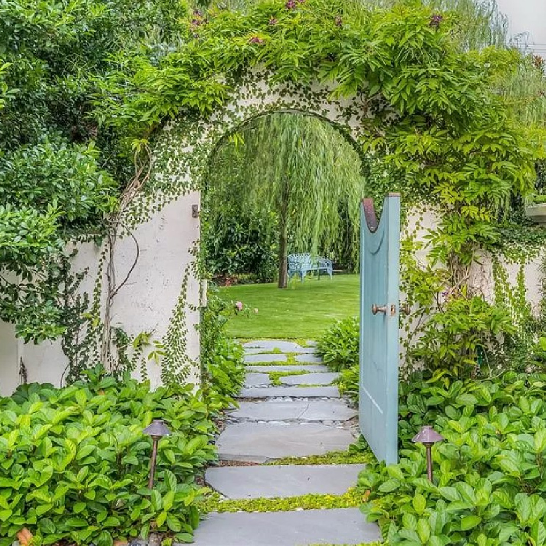 Beautiful arched entrance to garden at a French chateau in Houston.