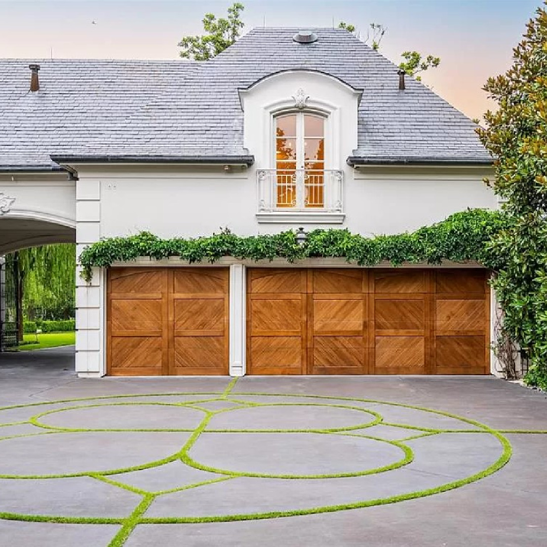 Lovely facade of garage at a French chateau in Houston with breathtaking architecture and landscaping.