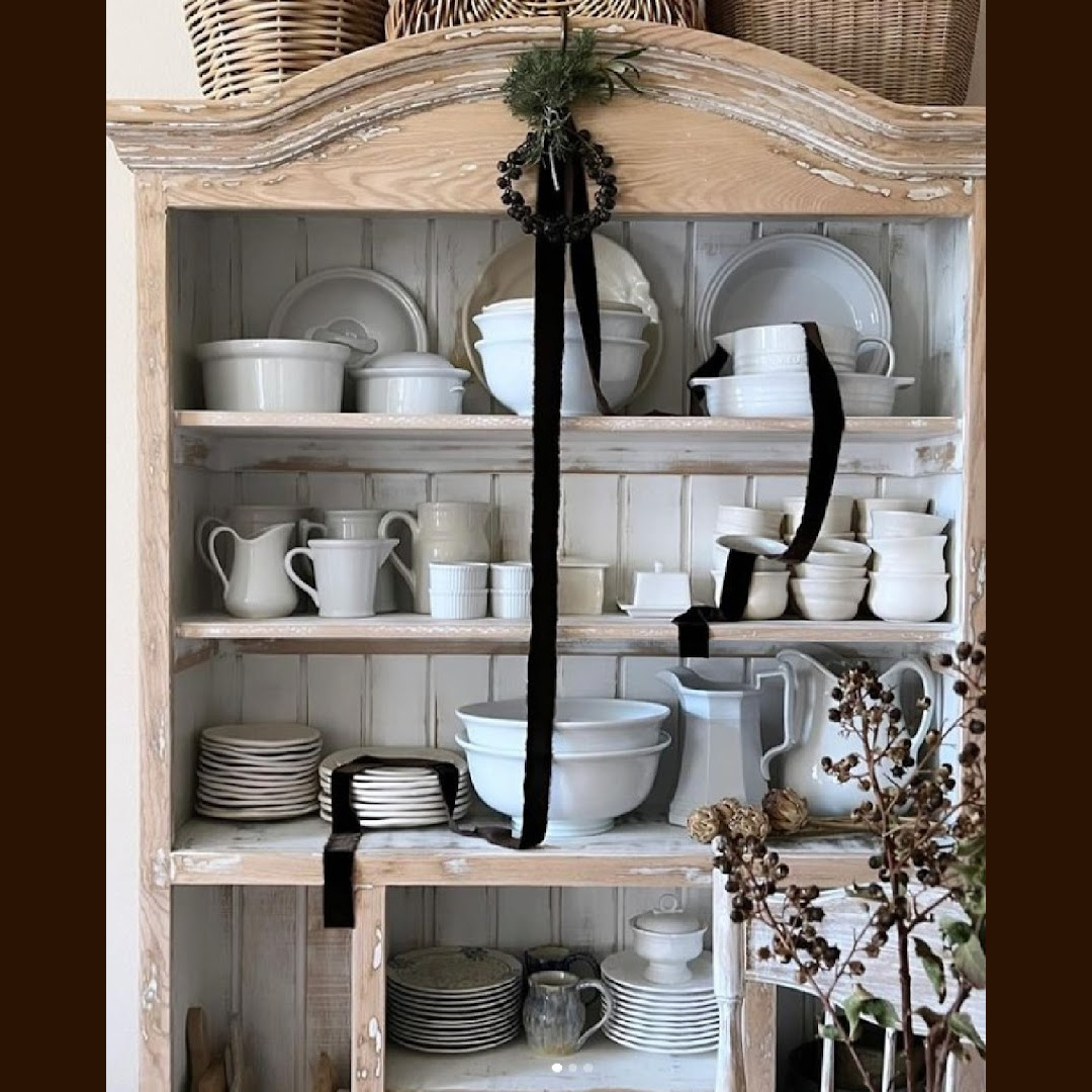 French country cupboard with brown velvet ribbon decoration for Christmas - Burlapluxe. #frenchcountrychristmas #frenchcupboard #holidaydecor