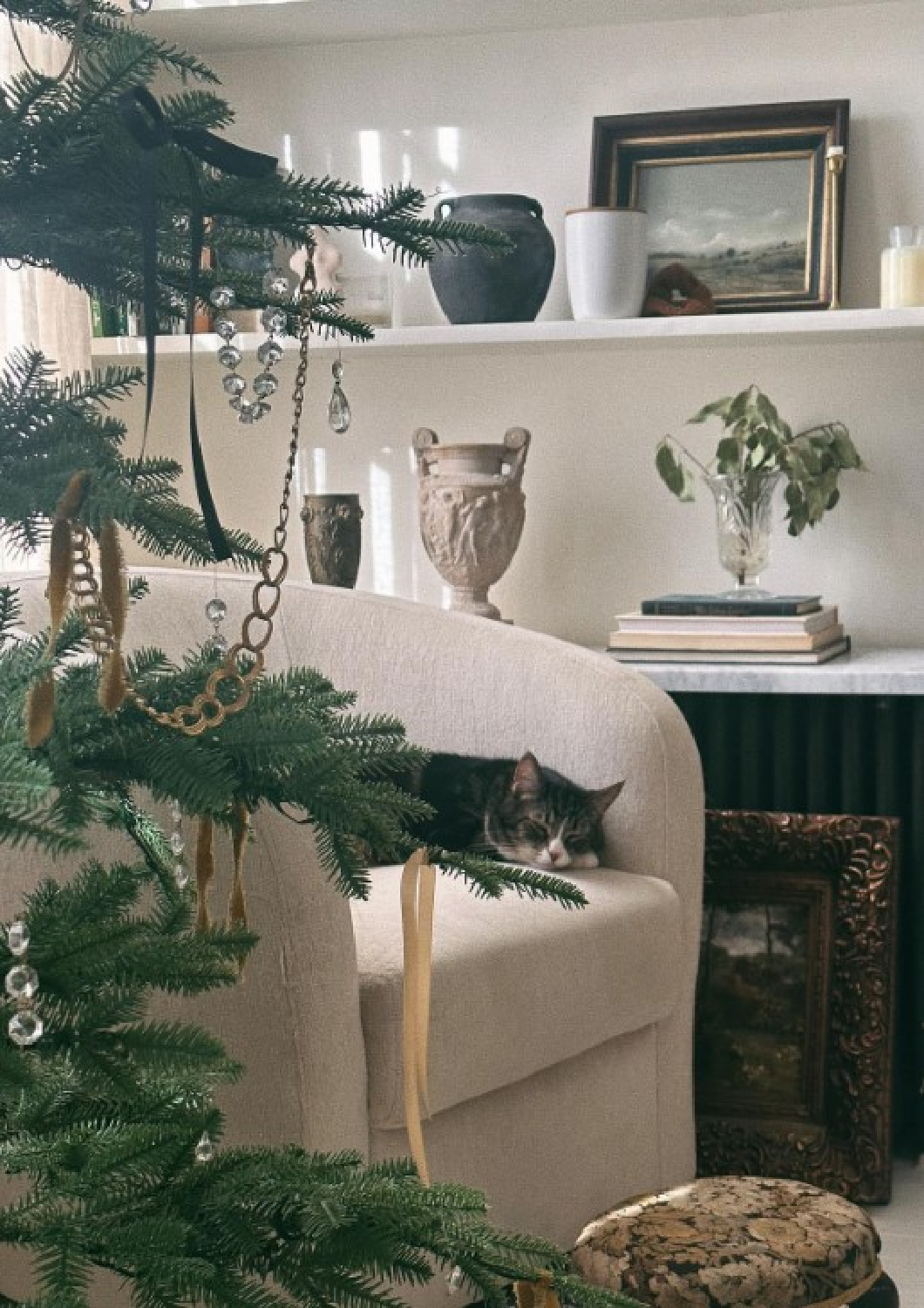 Cozy cat sleeping in serene French inspired holiday decorated home by Hummusbirrd. #frenchcountrychristmas