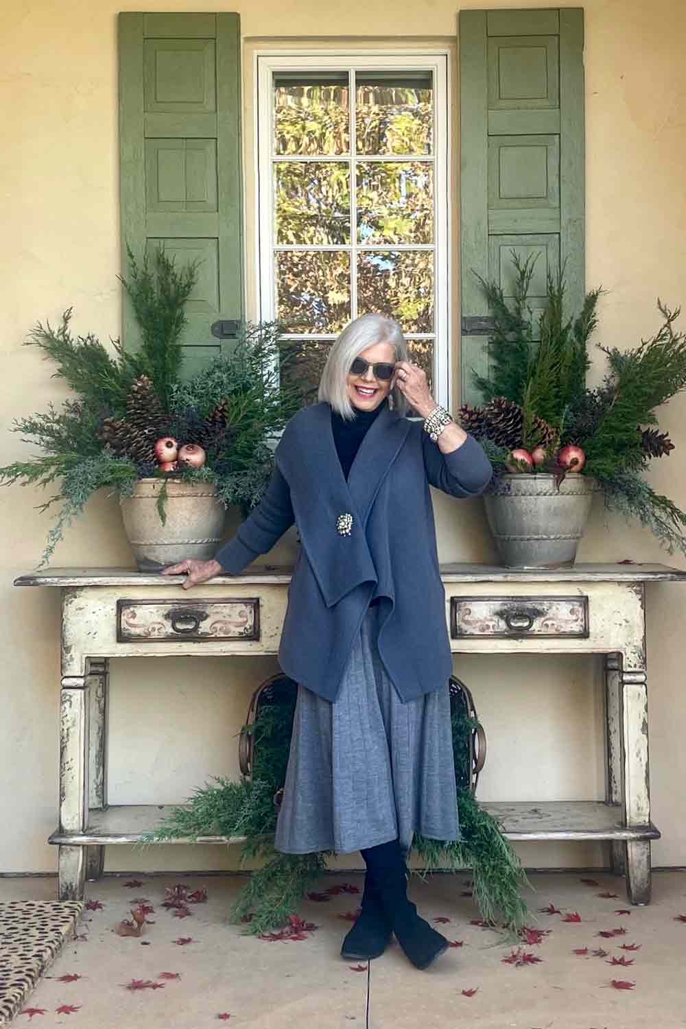 Designer Cindy Hattersley in a Margaret O'Leary cardigan to which she added a festive brooch for the holidays. #fashionover50 #vintagebrooch