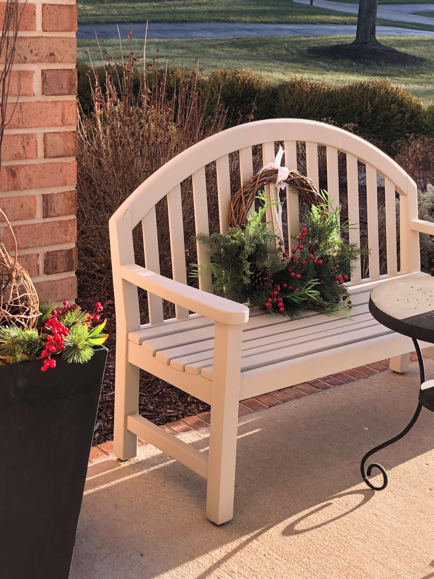 Front porch with bench and holiday wreath, 2023 - Hello Lovely Studio.