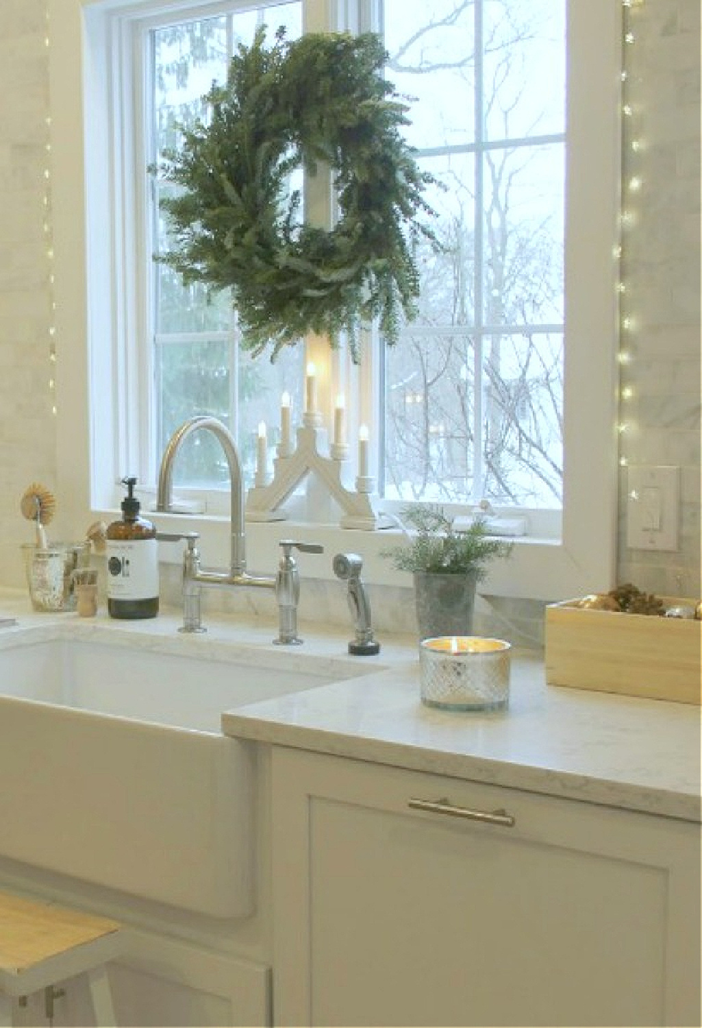 Fraser Fir wreatch and Swedish wooden candelabra at my kitchen farm sink - Hello Lovely. #farmhousechristmas #scandichristmas #hellolovelychristmas