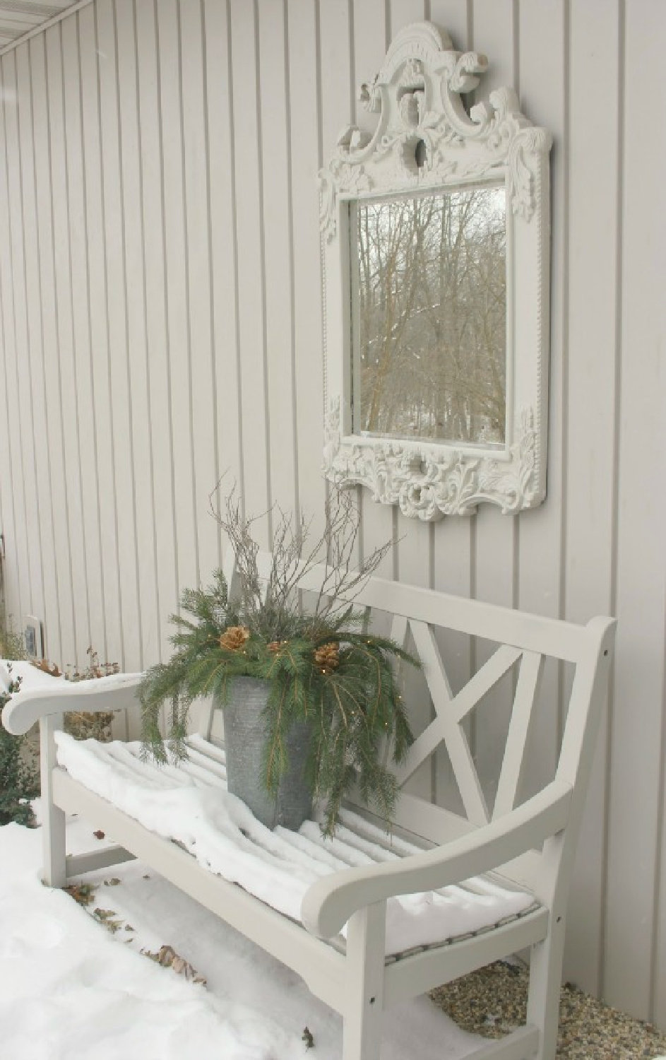 Christmas rustic touches in my French courtyard with mirror and bench - Hello Lovely Studio. #hellolovelychristmas #scandichristmas