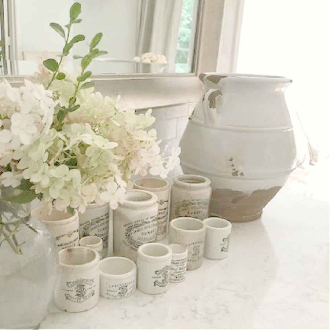 Hello Lovely's modern French kitchen with Viatera Minuet quartz counters, vintage English crocks, and terracotta urn. #modernfrench #hellolovelystudio