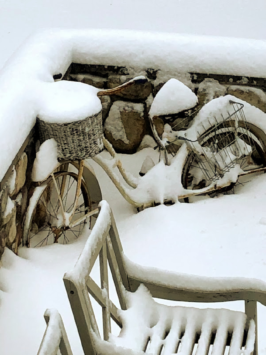 Hello Lovely's winter snowy French country courtyard with vintage bicycle covered in snow. #hellolovelychristmas