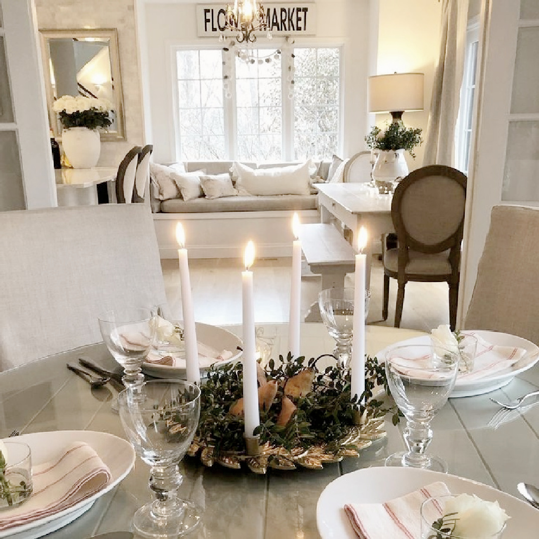 Christmas advent wreath with lit candles on my holiday table - Hello Lovely Studio. #hellolovelychristmas #adventwreaths #scandichristmas