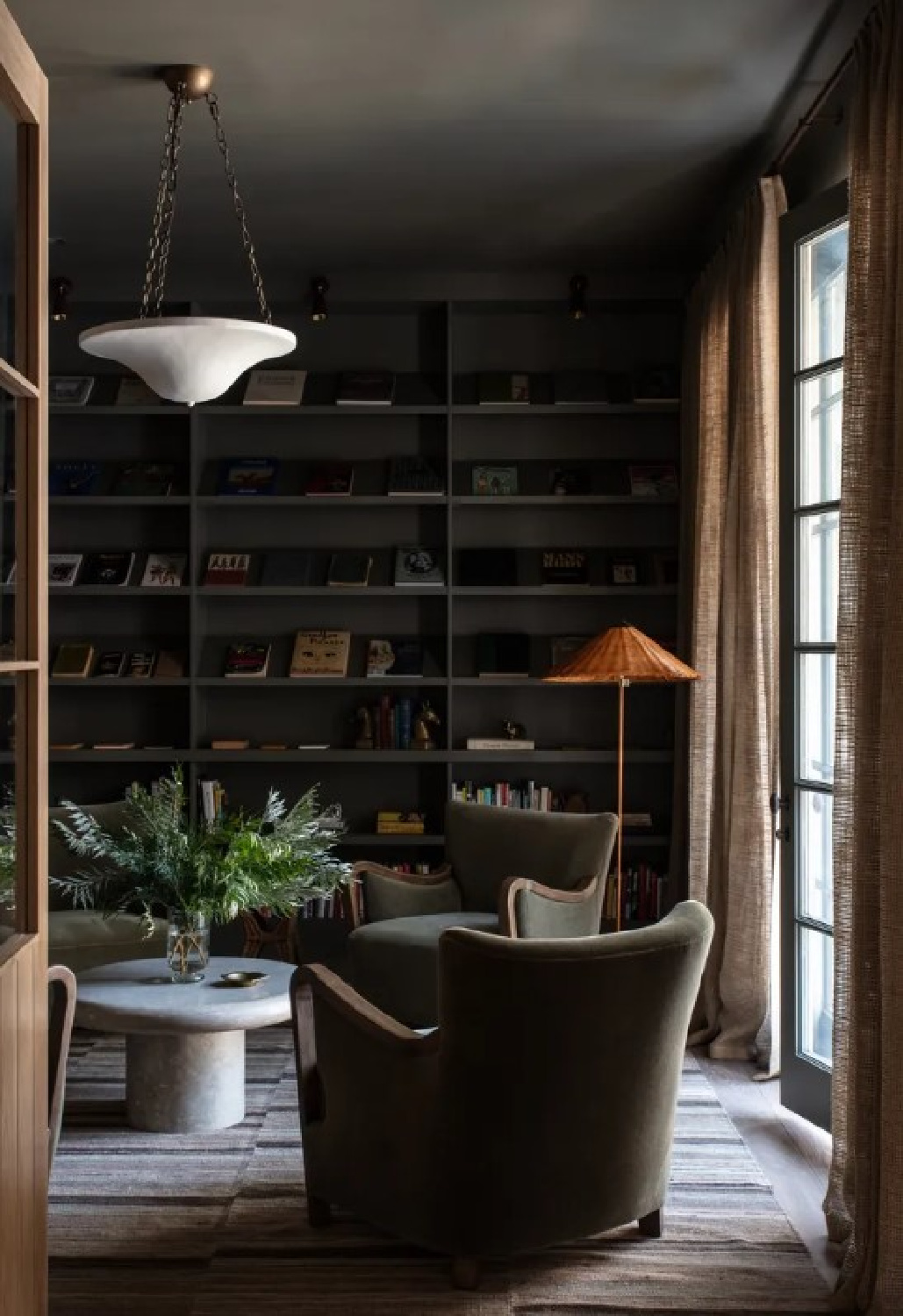 Jake Arnold designed cozy snug library with curby club chairs, stripe rug, dark moody gray-green walls and ceiling (photo Michael Clifford). 