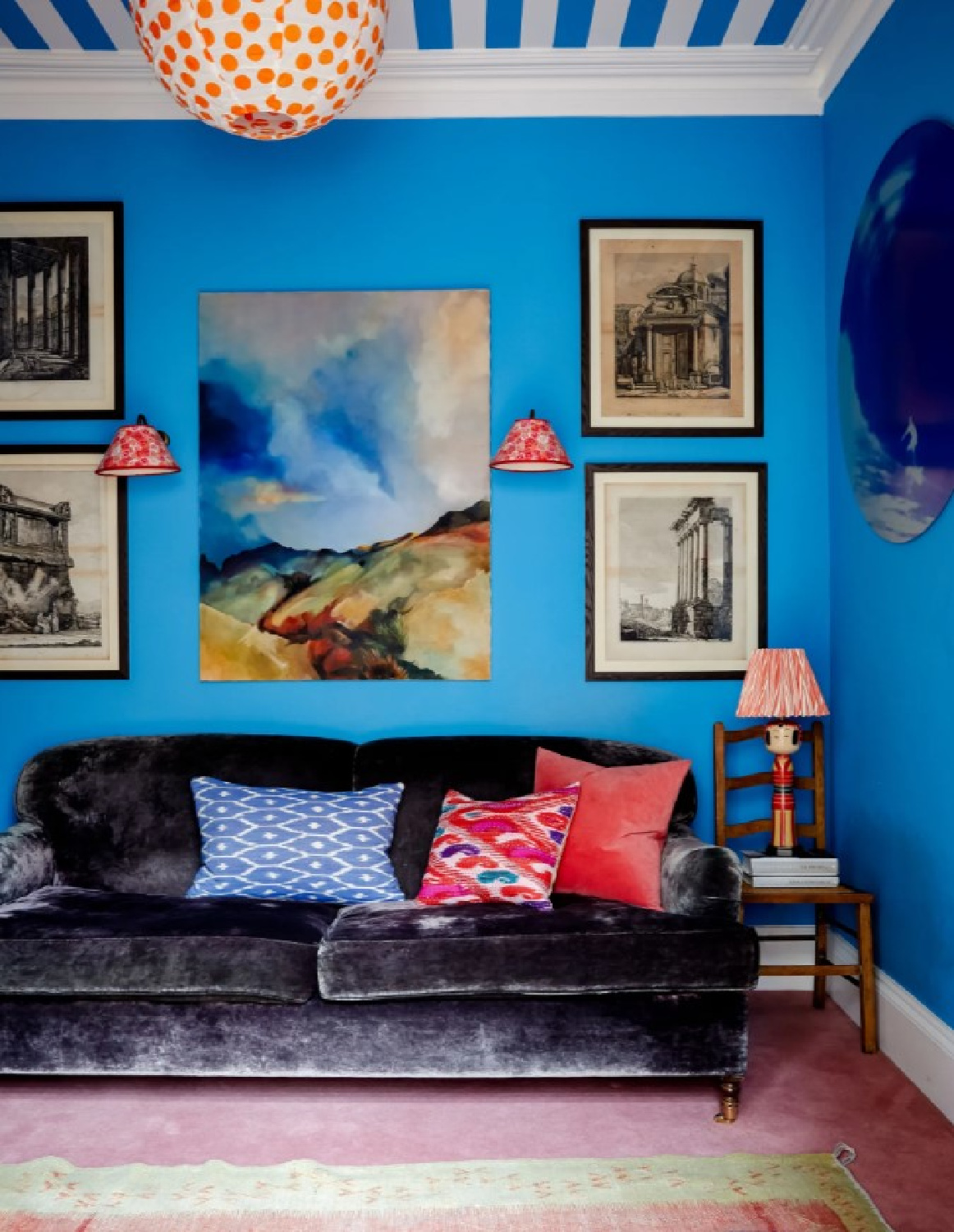 Velvet sofa and unexpected color combination in a Rosi de Ruig bright blue snug room with stripe ceiling (photo Paul Massey for House & Garden UK). 