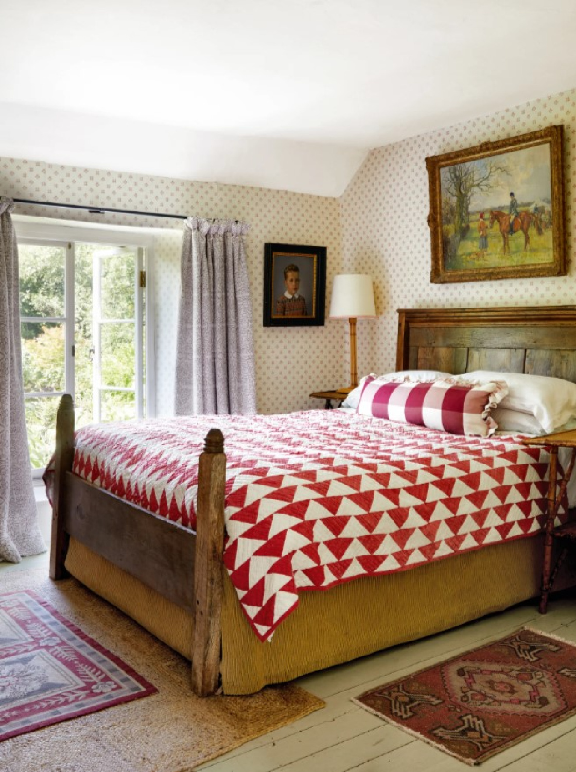 Cozy and humble English country cottage bedroom with red quilt and wallpaper - Sarah Hiscox in House & Garden UK. #englishcountry