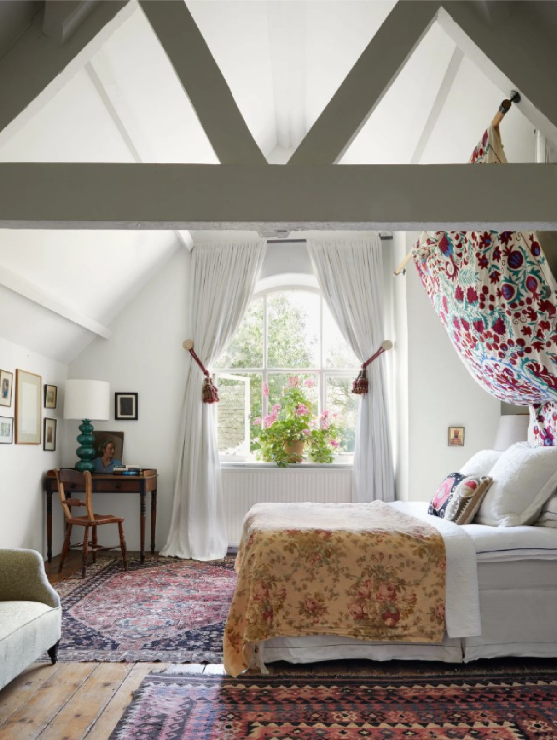 Beautiful bedroom with lofty ceiling at Cotswold home of Renshaw and Sarah Hiscox in HouseandGardenUK (photo Paul Massey). #cotswoldcottage #englishcountrystyle