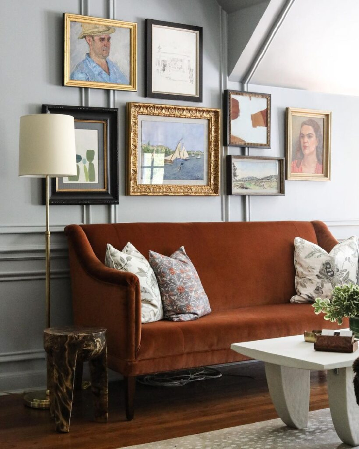 Park and Oak - beautiful pumpkin spice settee and gallery wall in an elegant interior with panel moldings. #gallerywalls #europeancountry #belgianstyle