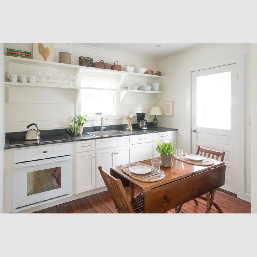 Smart choices in a renovated kitchen of a South Carolina cottage kitchen with shiplap, wood floors, and open shelving - Southern Living.