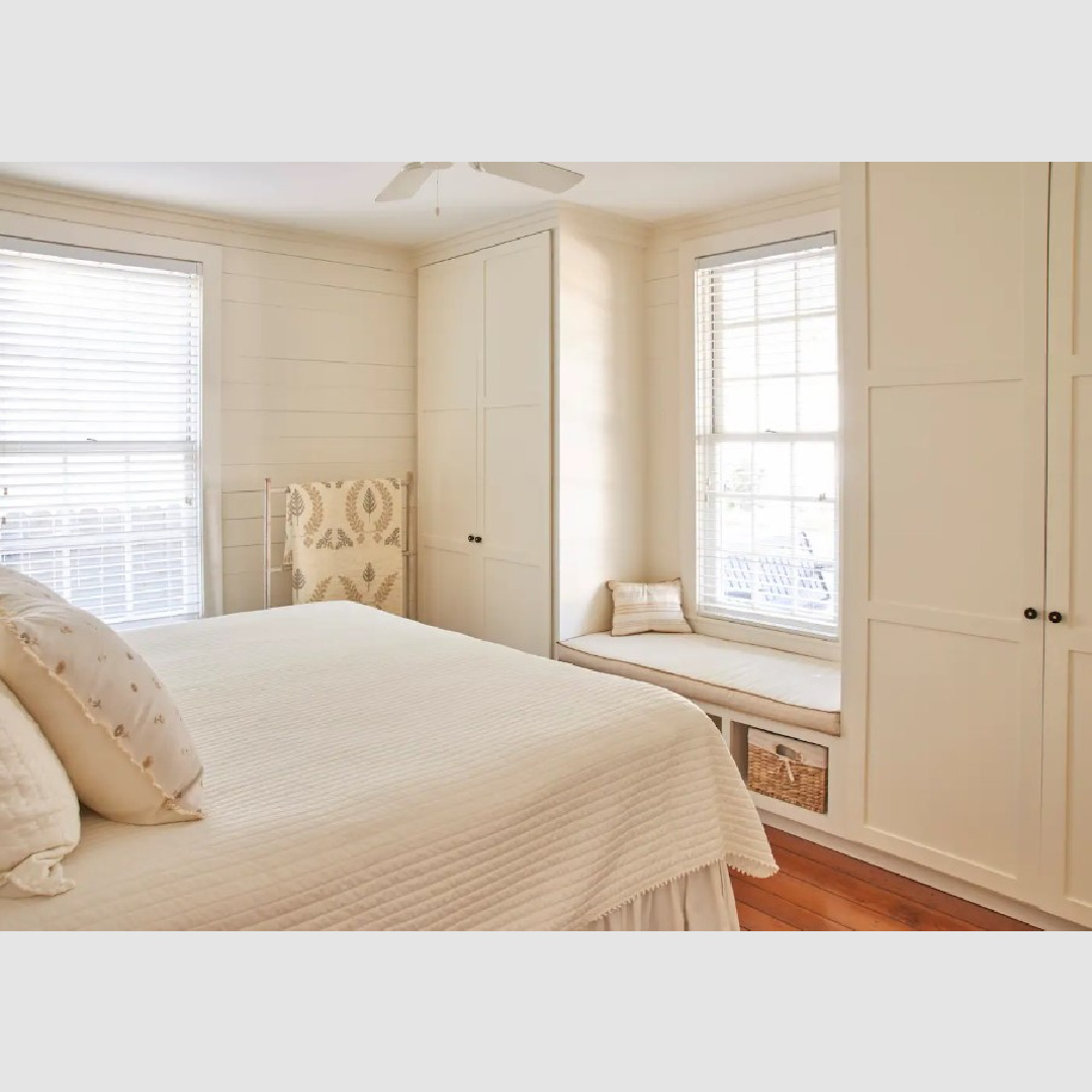 Plywood built-in wardrobes and window seat in a smartly renovated Southern cottage bedroom with shiplap - Southern Living.