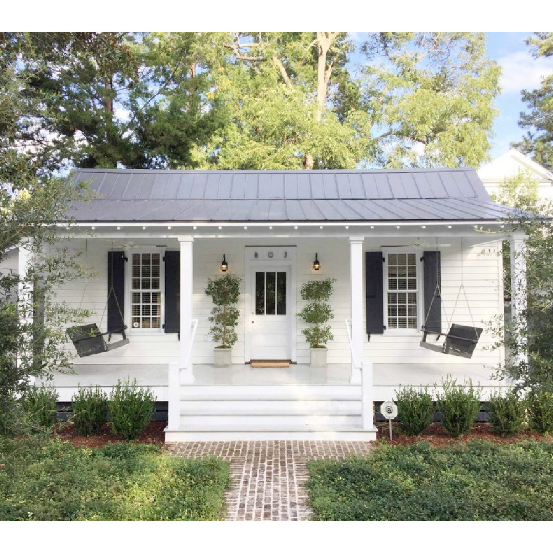 Small (660 sf)1800s white low country Southern cottage with front porch and porch swings in Beaufort, SC. Airbnb. #cottagearchitecture #southerncottage #cottagestyle #tinycottages