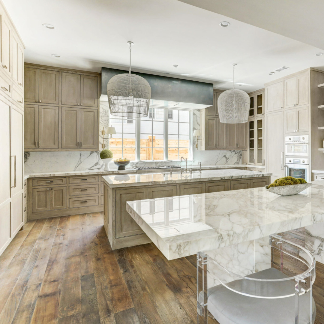 Bespoke kitchen with reclaimed oak flooring at 3637 Meadow Lake, Houston home by Elron with Chateau Domingue finishes, flooring, and paneled library by Segreto Finishes. #oldworldstyle #europeanarchitecture #houstonhomes