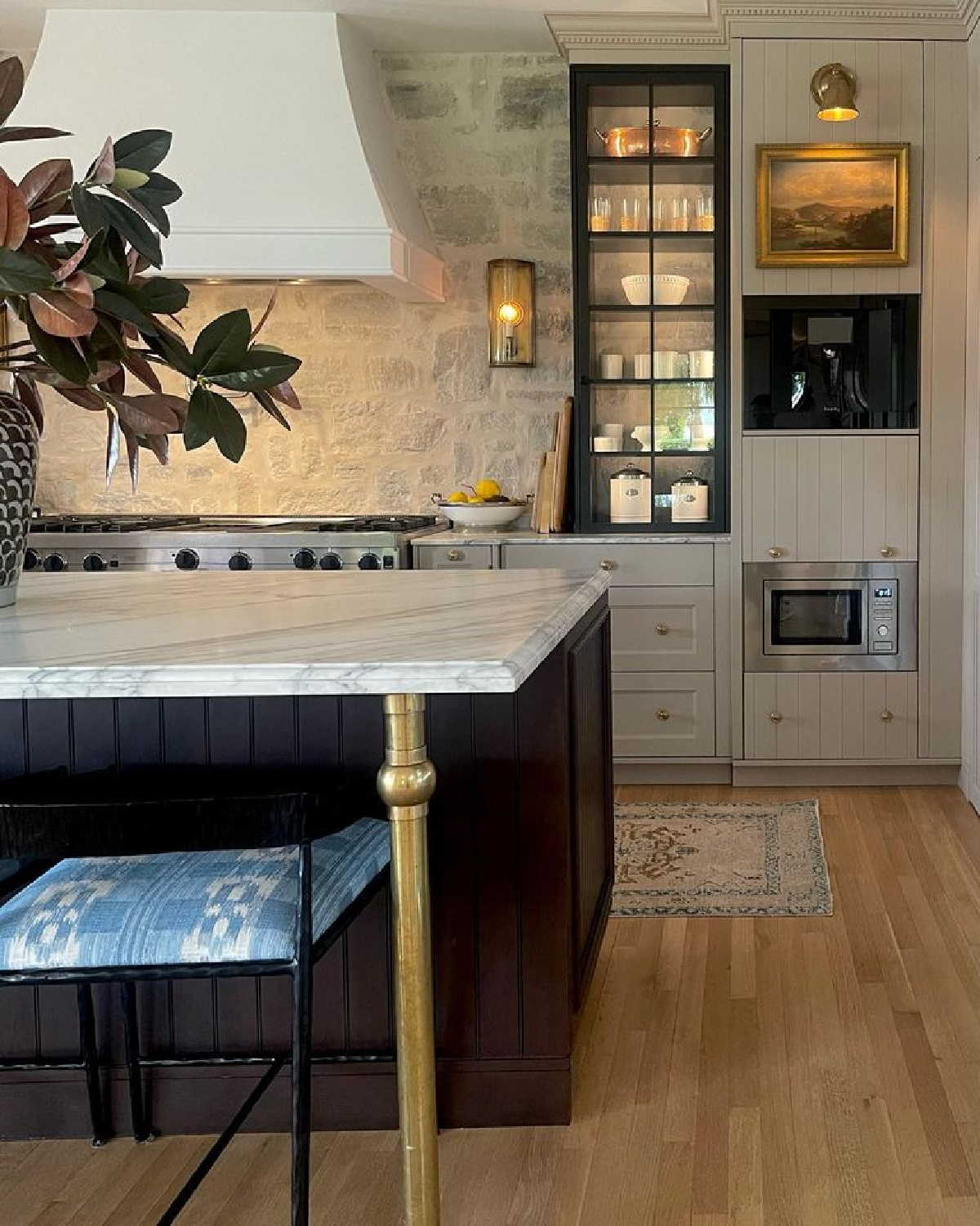 Farrow & Ball Jitney on cabinets in beautiful timeless kitchen with over-grouted stone backsplash and putty cabinets - @m_m_interior_design. #farrowandballjitney #timelesskitchen #stonebacksplash #europeanluxury
