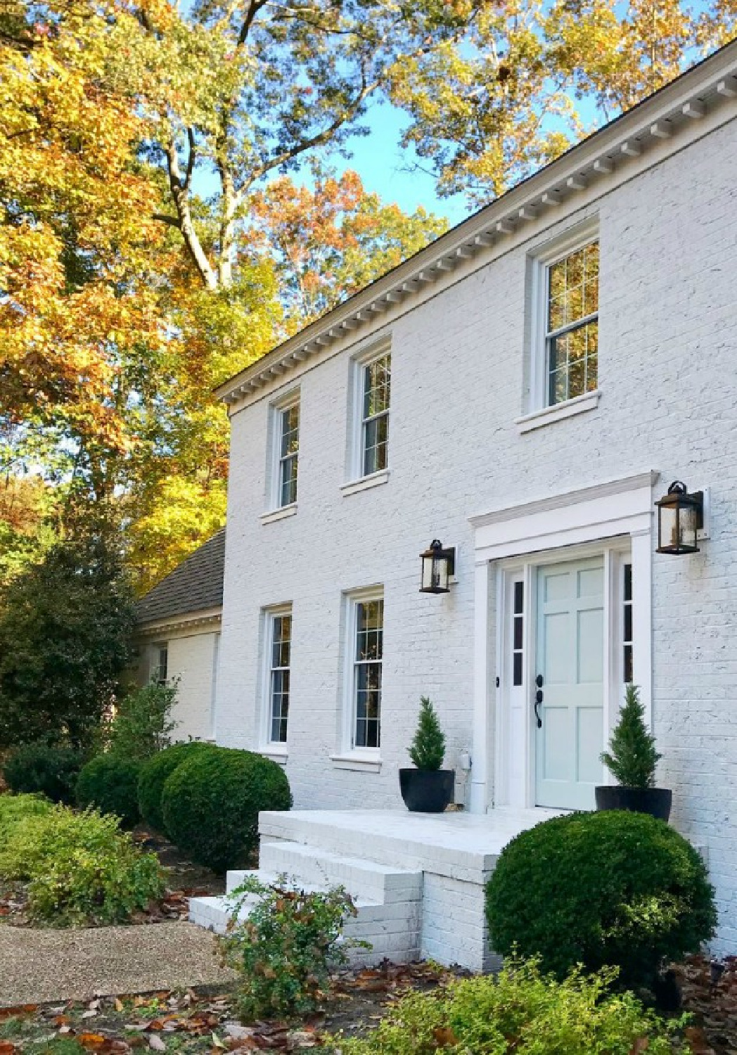 Moderne White (Sherwin Williams) on a painted brick house exterior - Young House Love. Door is Benjamin Moore Tranquility. #whitebrickhouse #modernewhite #swmodernewhite #benjaminmooretranquility