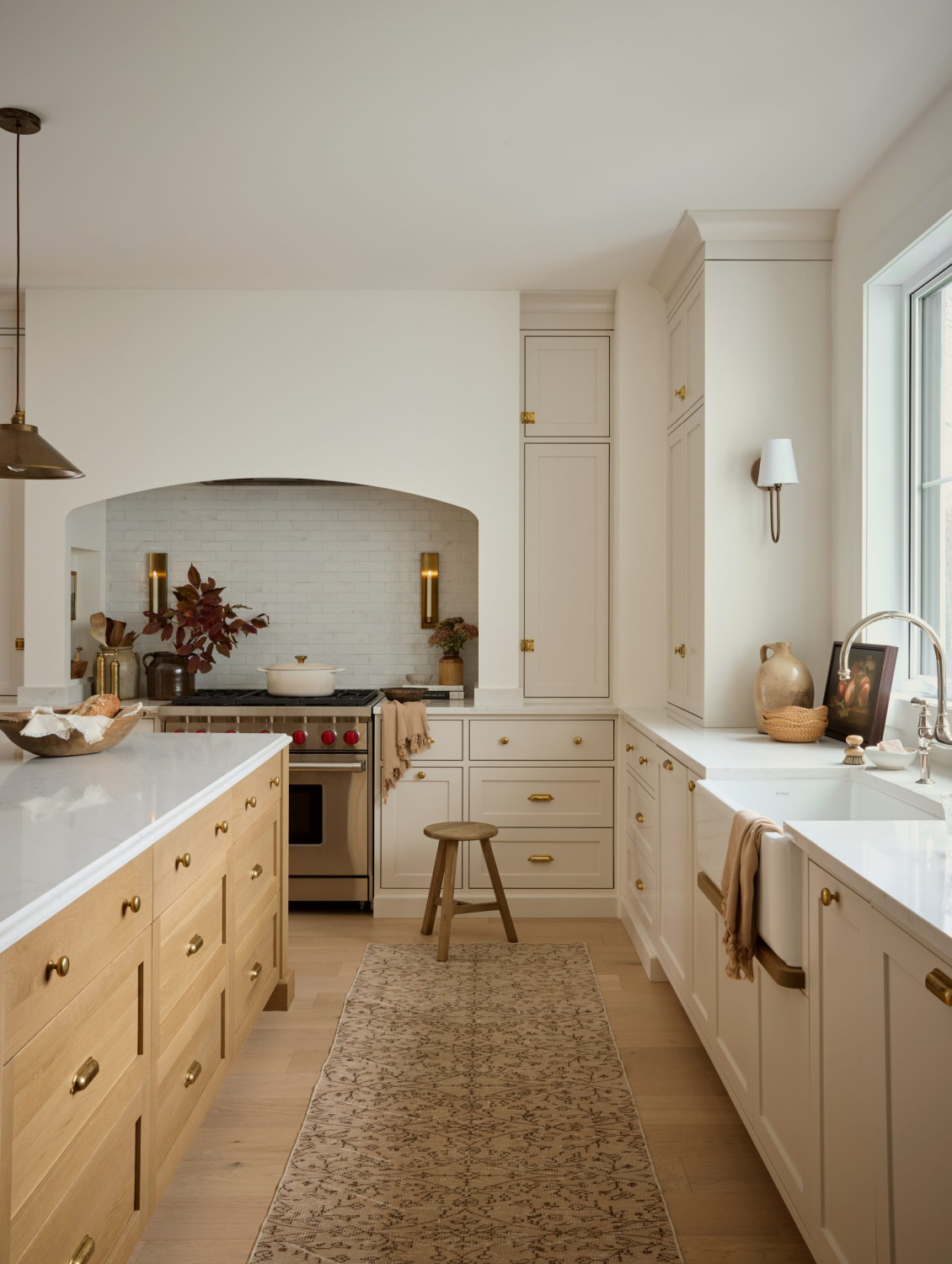 Benjamin Moore PALE OAK on kitchen cabinets in a gorgeous warm, European inspired luxe kitchen by AKB Design. #benjaminmoorepaleoak #warmwhitekitchen #whitekitchencabinetcolor