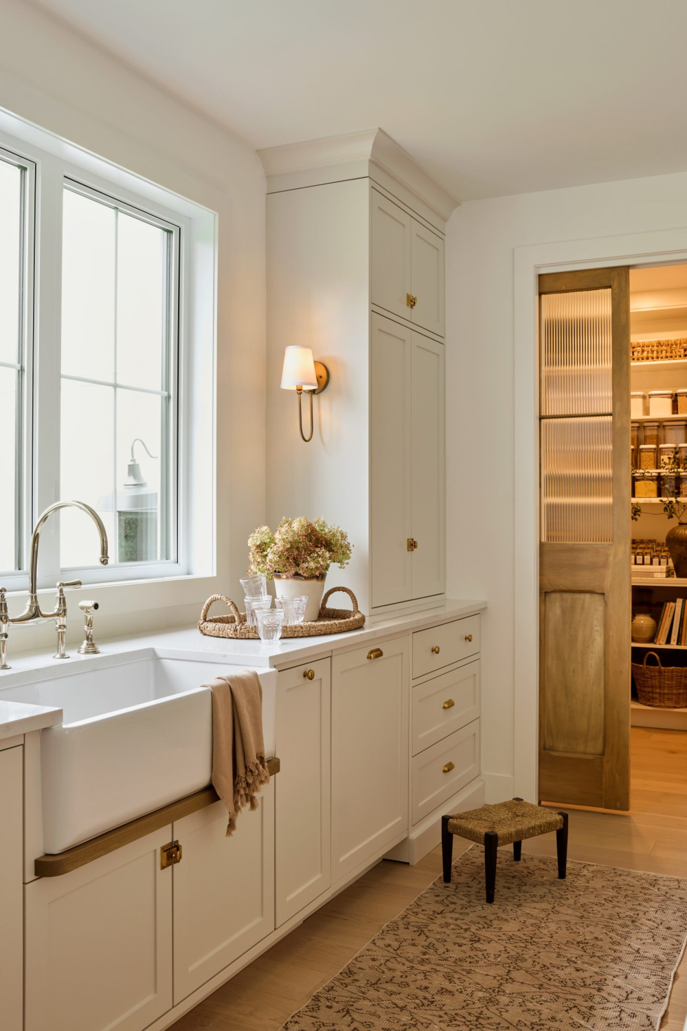 Benjamin Moore PALE OAK on kitchen cabinets in a gorgeous warm, European inspired luxe kitchen by AKB Design. #benjaminmoorepaleoak #warmwhitekitchen #whitekitchencabinetcolor