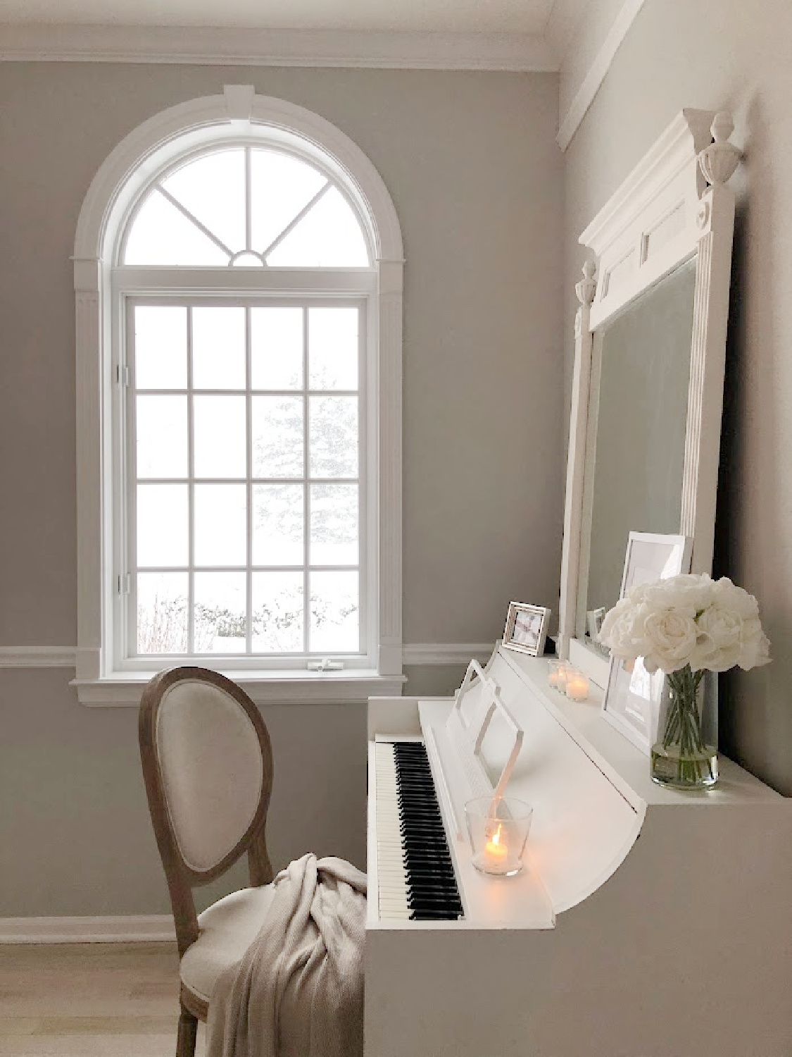 Serene winter vignette with my white piano as it snows - Hello Lovely Studio. #hellolovelyhome