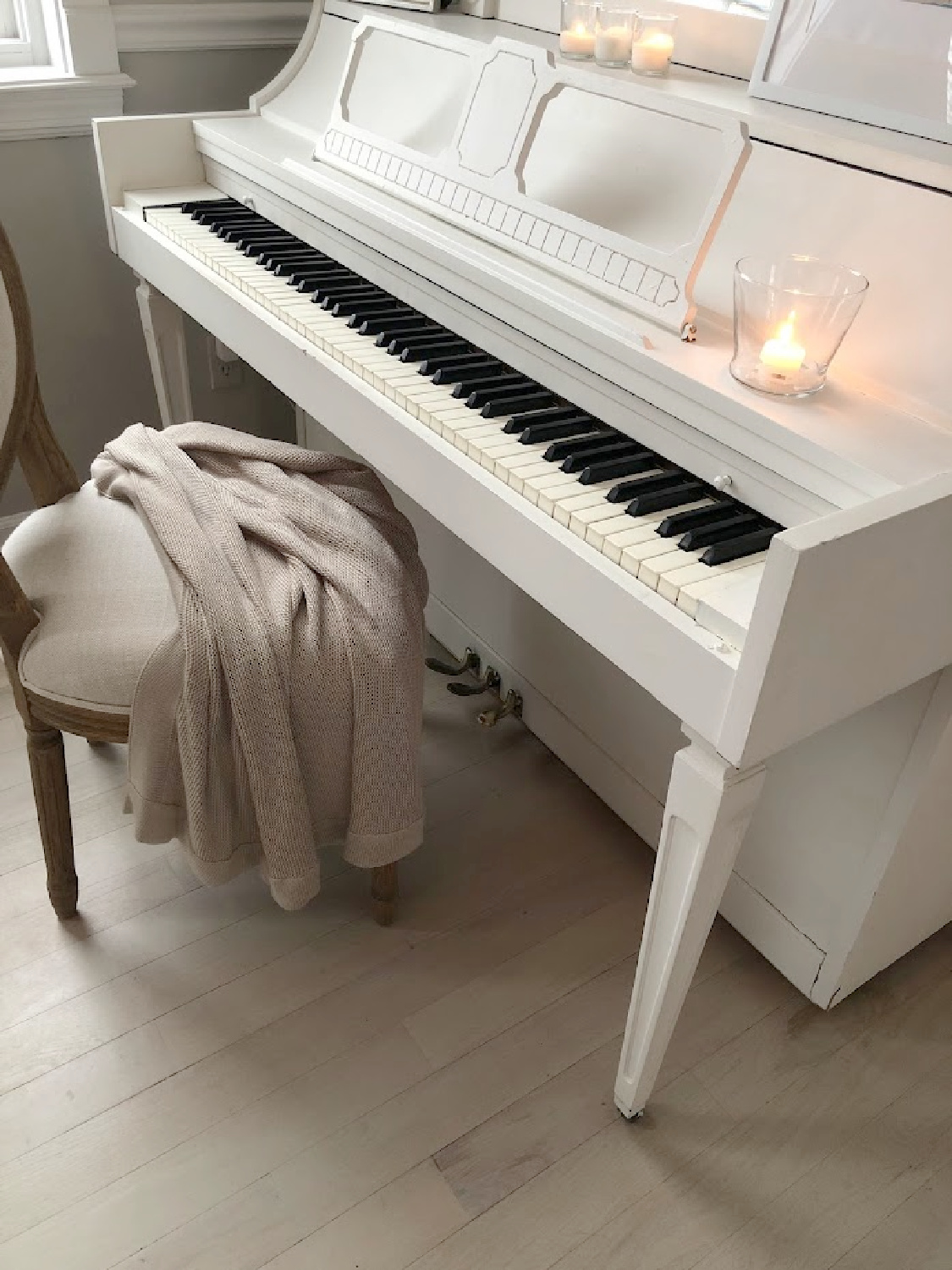 Serene winter vignette with my white piano as it snows - Hello Lovely Studio. #hellolovelyhome