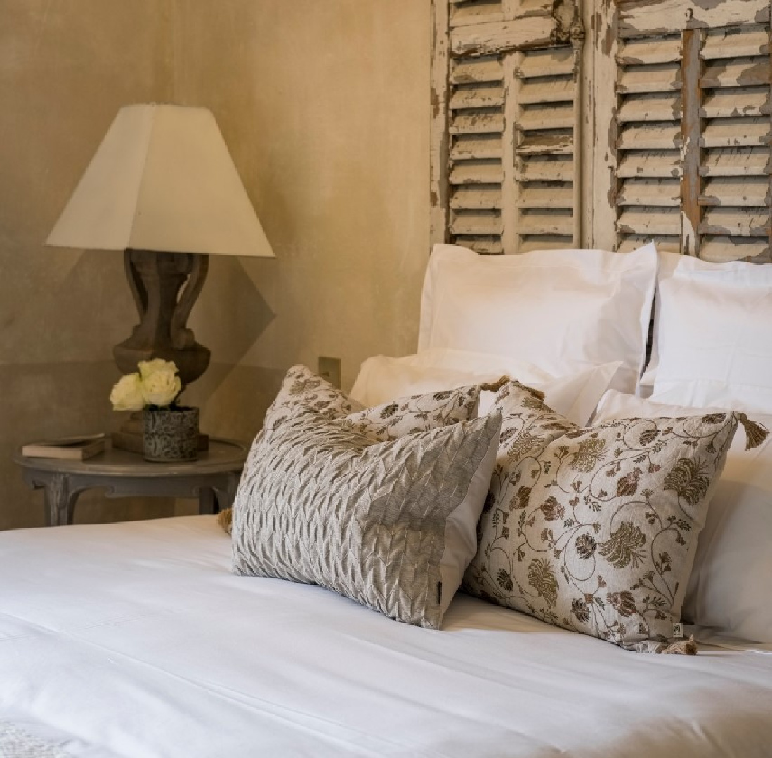 Rustic bedroom with warm European luxury and cozy opulence in a French vacation villa in Provence - La Bastide de Laurence. #frenchbastide #frenchvilla #luxuryvilla #provencevilla #frenchbedroom #cozyopulence #provencehomes #rusticelegance